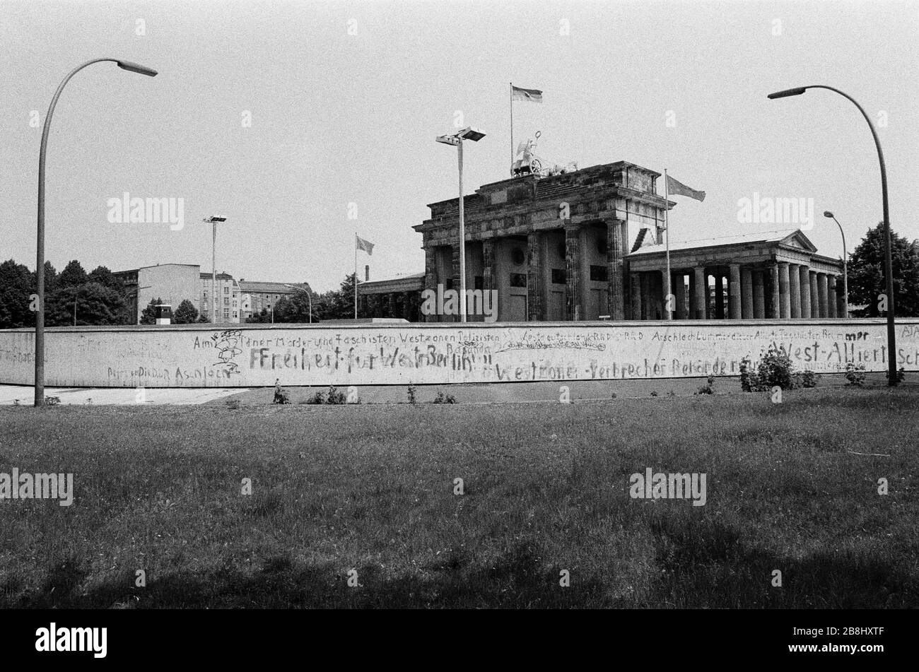 The section of the Berlin Wall at the Brandenburg Gate, seen from the western side of the divide. The Berlin Wall was a barrier constructed by the German Democratic Republic (GDR, East Germany) starting on 13 August 1961, that completely cut off West Berlin from surrounding East Germany and from East Berlin. The Wall was opened on 9. November 1989 allowing free movement of people from east to west. Stock Photo