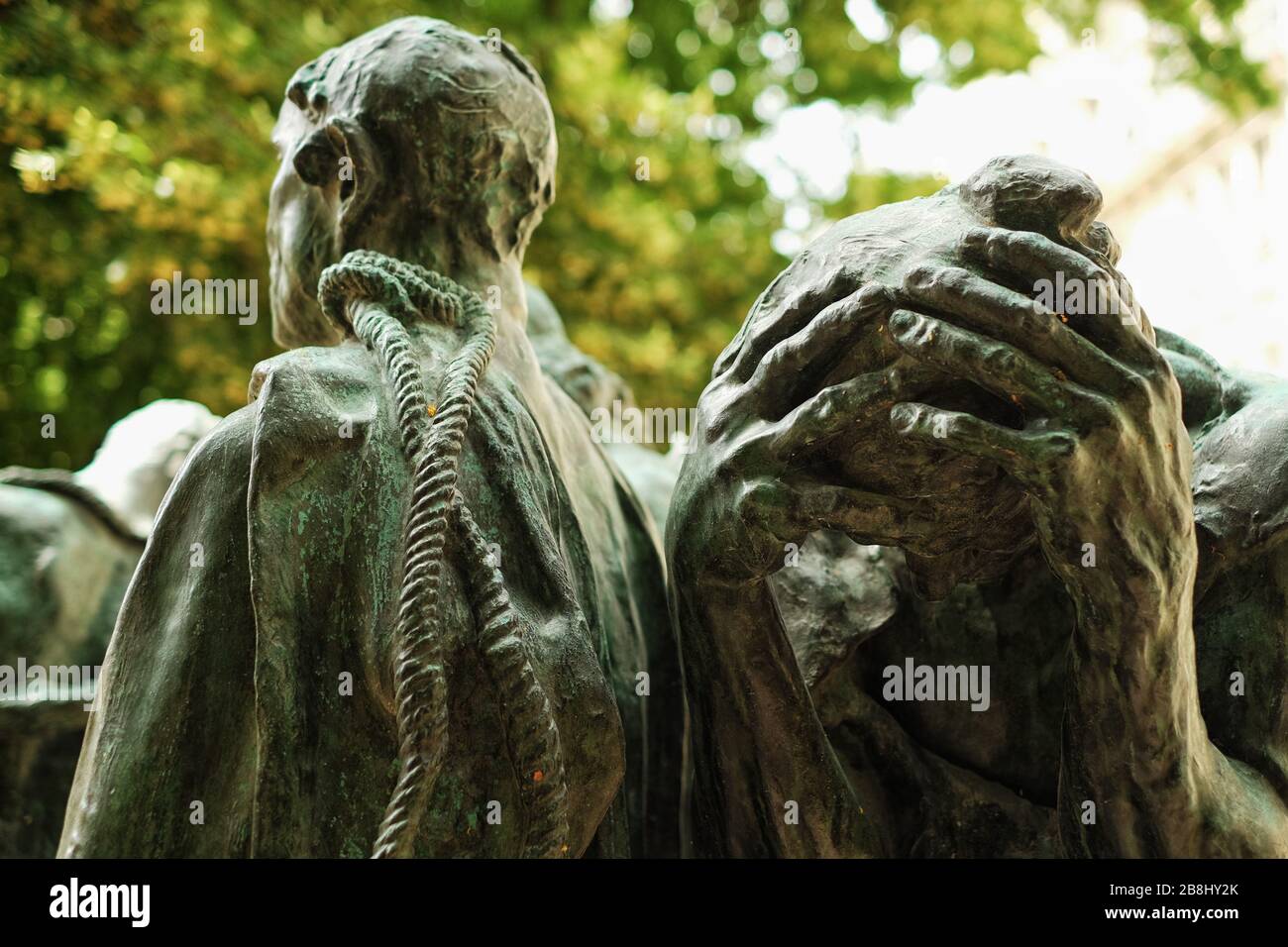 Hands clasped in despair, details of the head and shoulder, face and hands of the The Burghers of Calais, in the sculpture garden, Musée Rodin, Paris Stock Photo