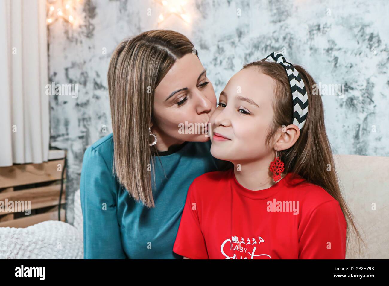 Young mom having kissing her daughte at christmas photo Stock Photo