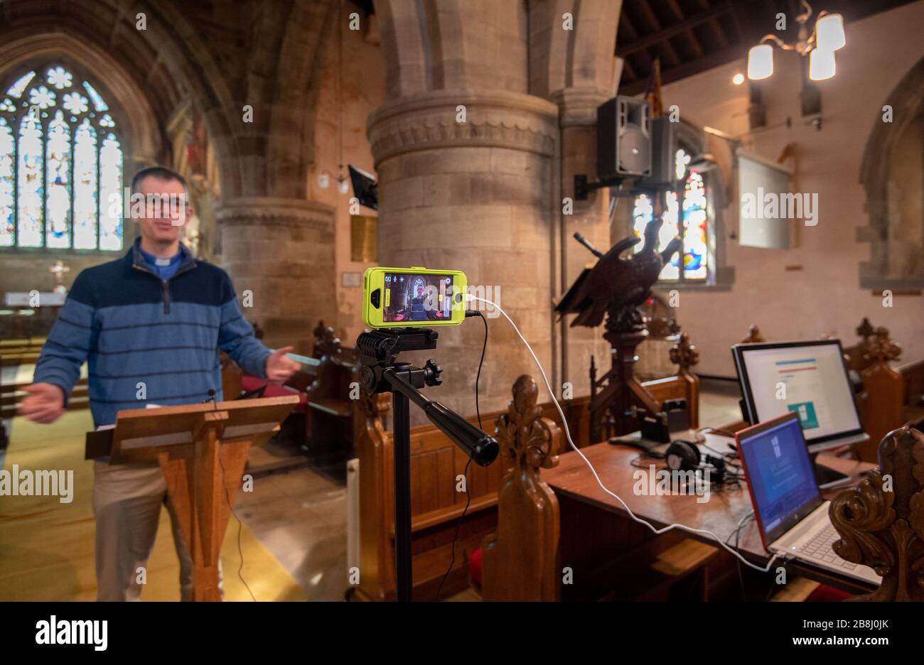 Rector Rob Miles gives his sermon during a live streaming of the Sunday church service at St Lukes Church in Thurnby, Leicester, after the archbishops of Canterbury and York wrote to clergy on Tuesday advising them to put public services on hold in response to Government advice to avoid mass gatherings to help prevent the spread of the Covid-19 virus. Stock Photo