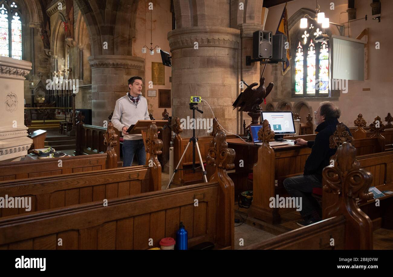 Assistant rector Tom Devas during a live streaming of the Sunday church service at St Lukes Church in Thurnby, Leicester, after the archbishops of Canterbury and York wrote to clergy on Tuesday advising them to put public services on hold in response to Government advice to avoid mass gatherings to help prevent the spread of the Covid-19 virus. Stock Photo