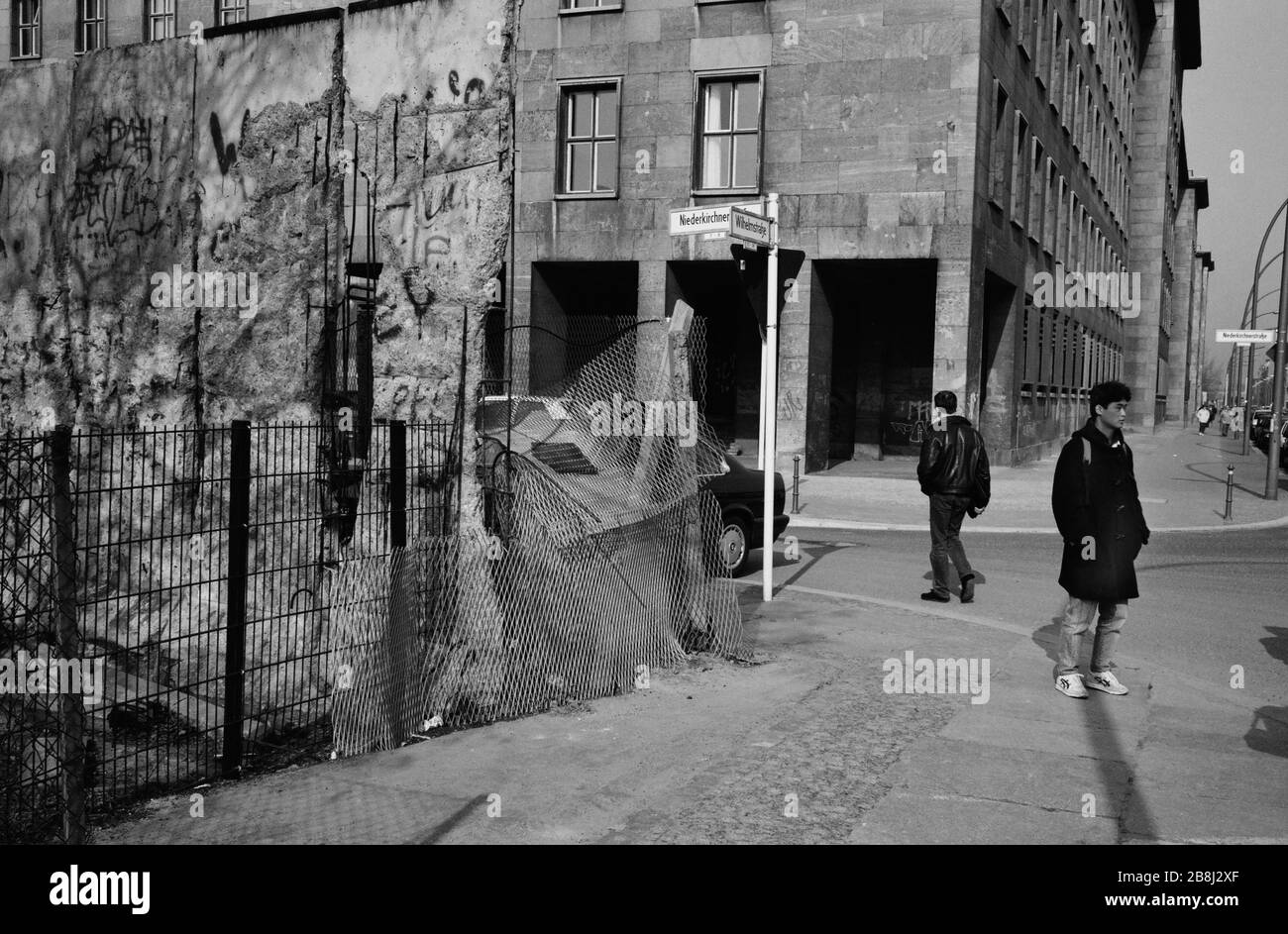 People crossing the former line of the Berlin Wall at Wilhelm Strasse