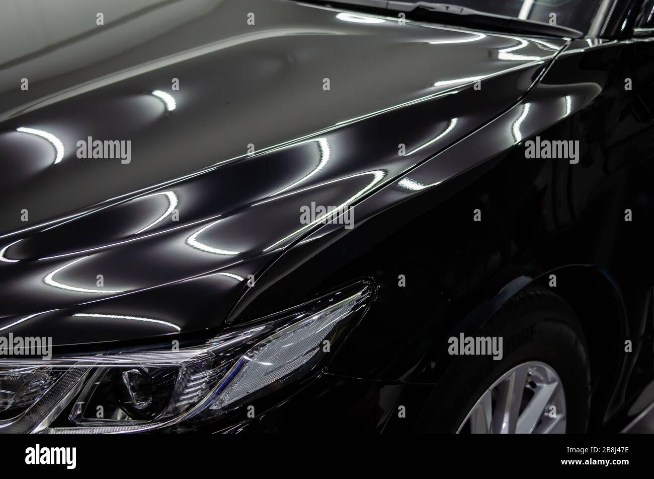 Metallic clean shiny black car paint hi-res stock photography and