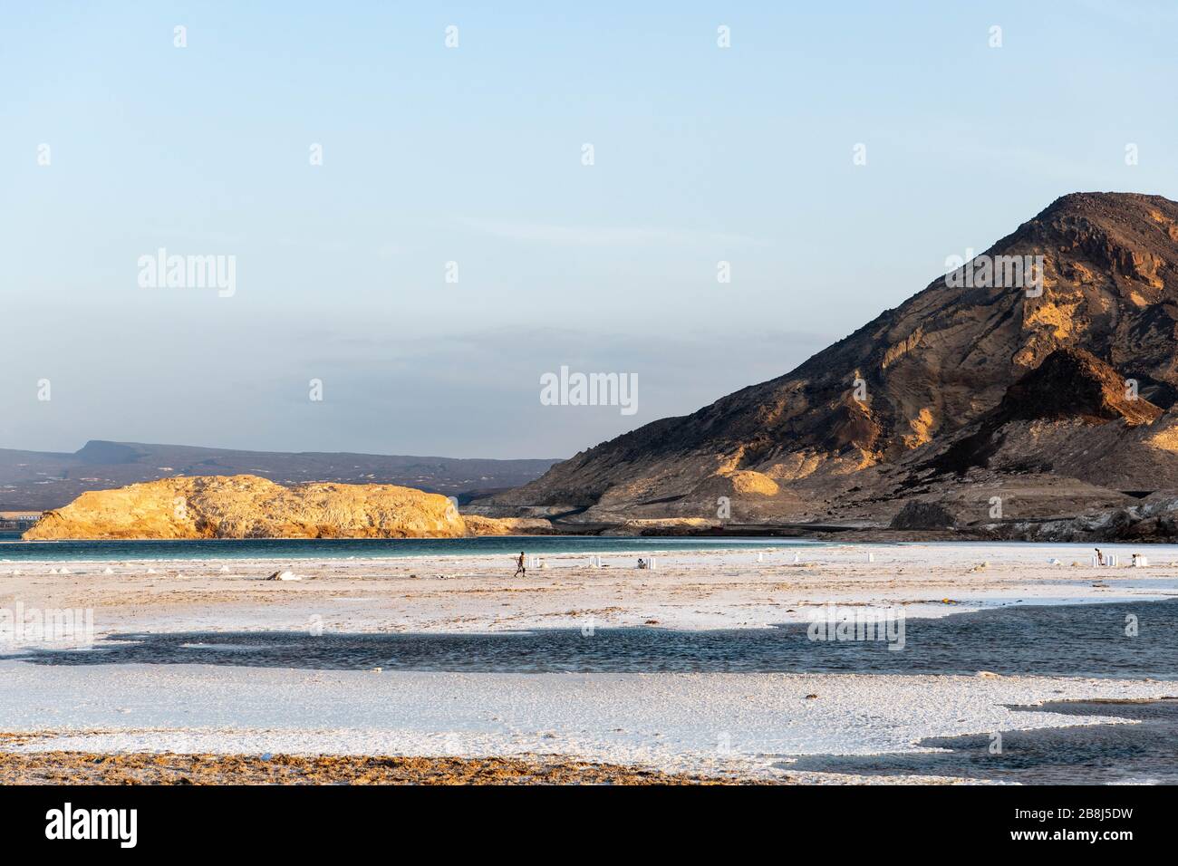 Africa, Djibouti, Lake Assal. Landscape view of lake Assal with people harvesting salt Stock Photo
