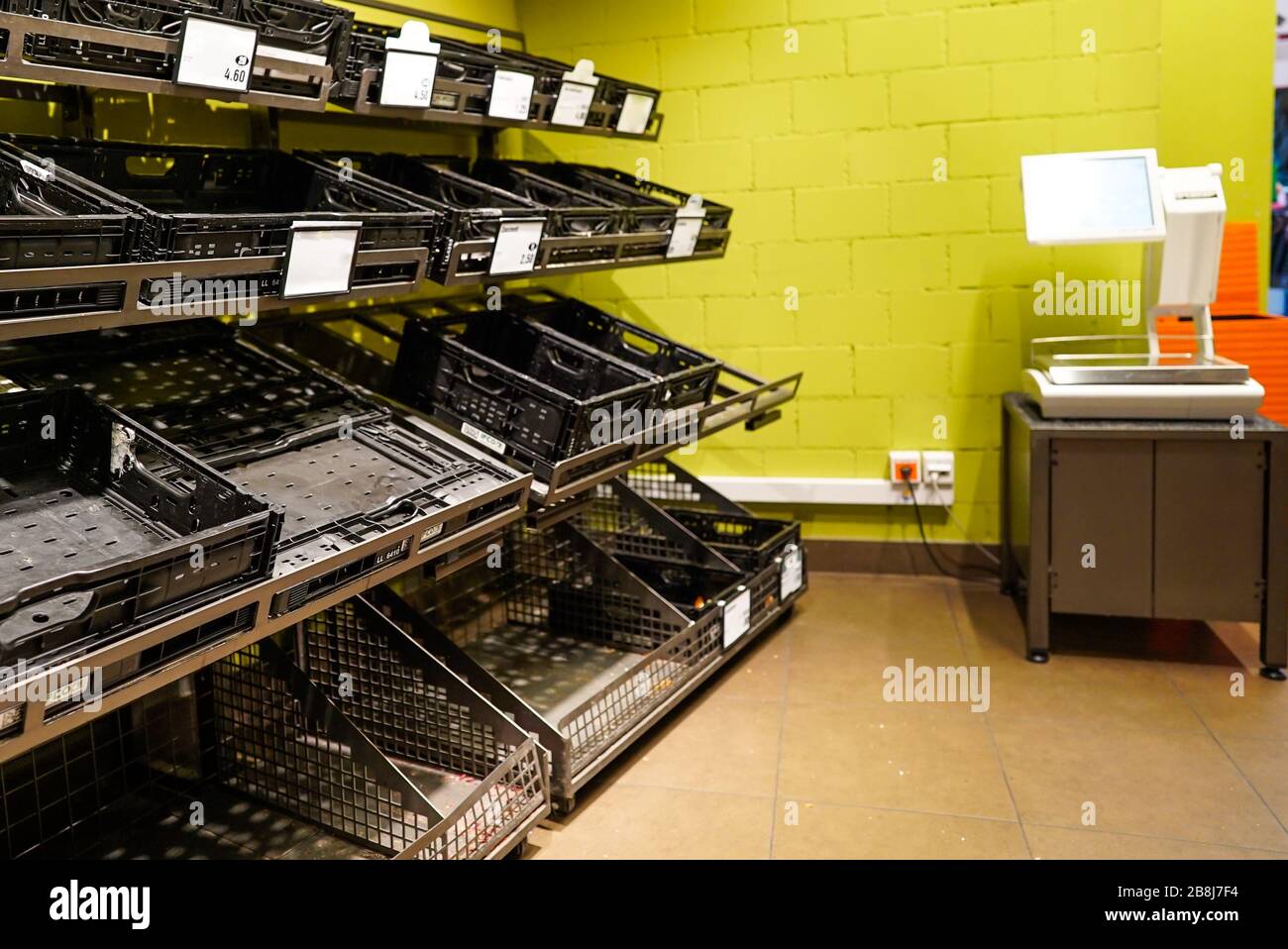 View of empty fruit and vegetable shelves in a European supermarket after buying food supplies because of Covid-19 Stock Photo