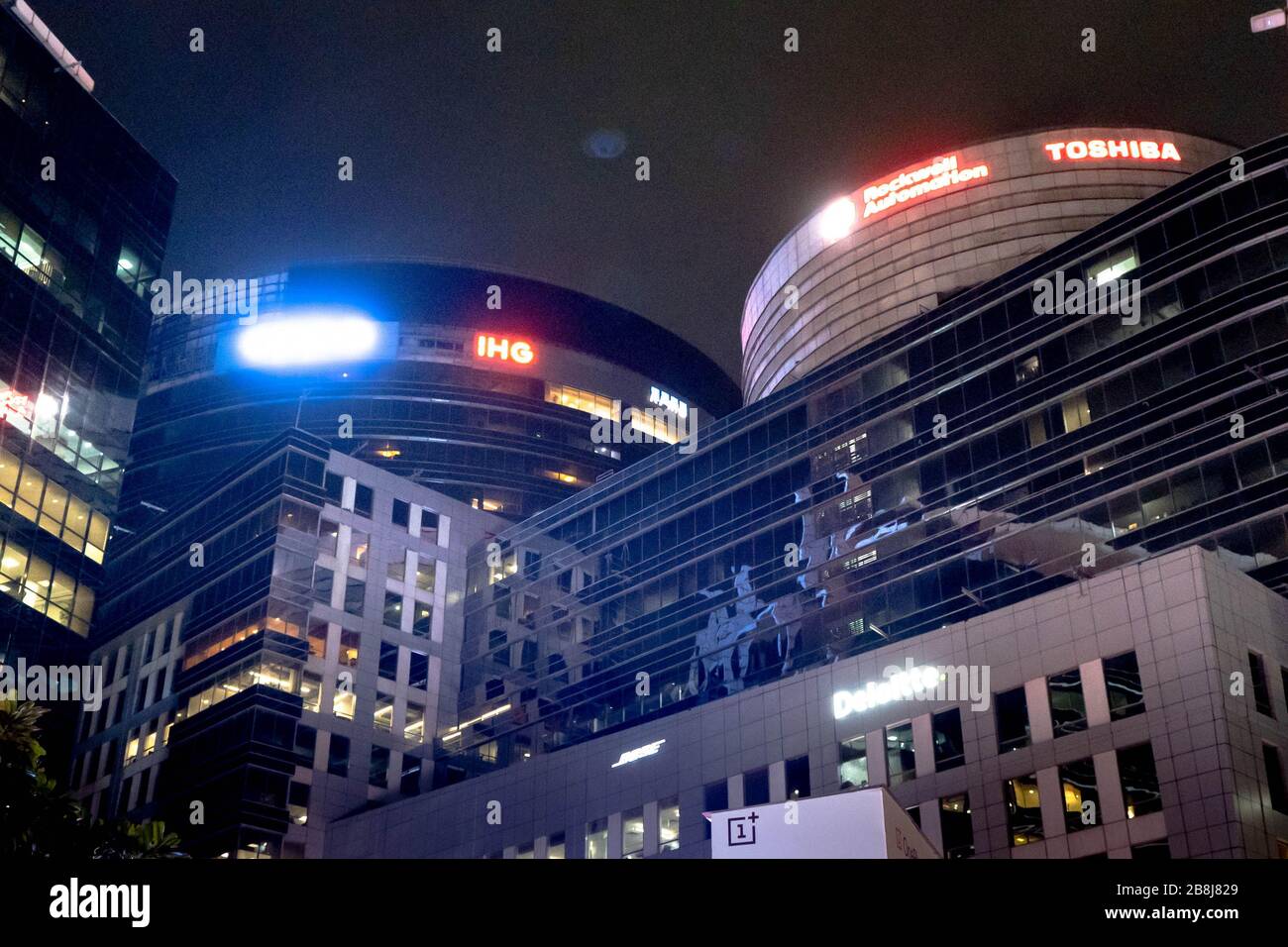 Night shot of huge skyscraper glass buildings with lit windows, lights