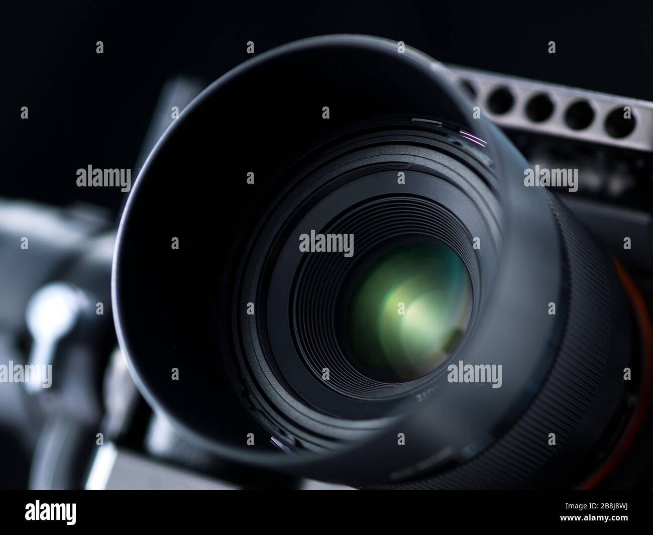 Professional digital camera on black background, lens close up