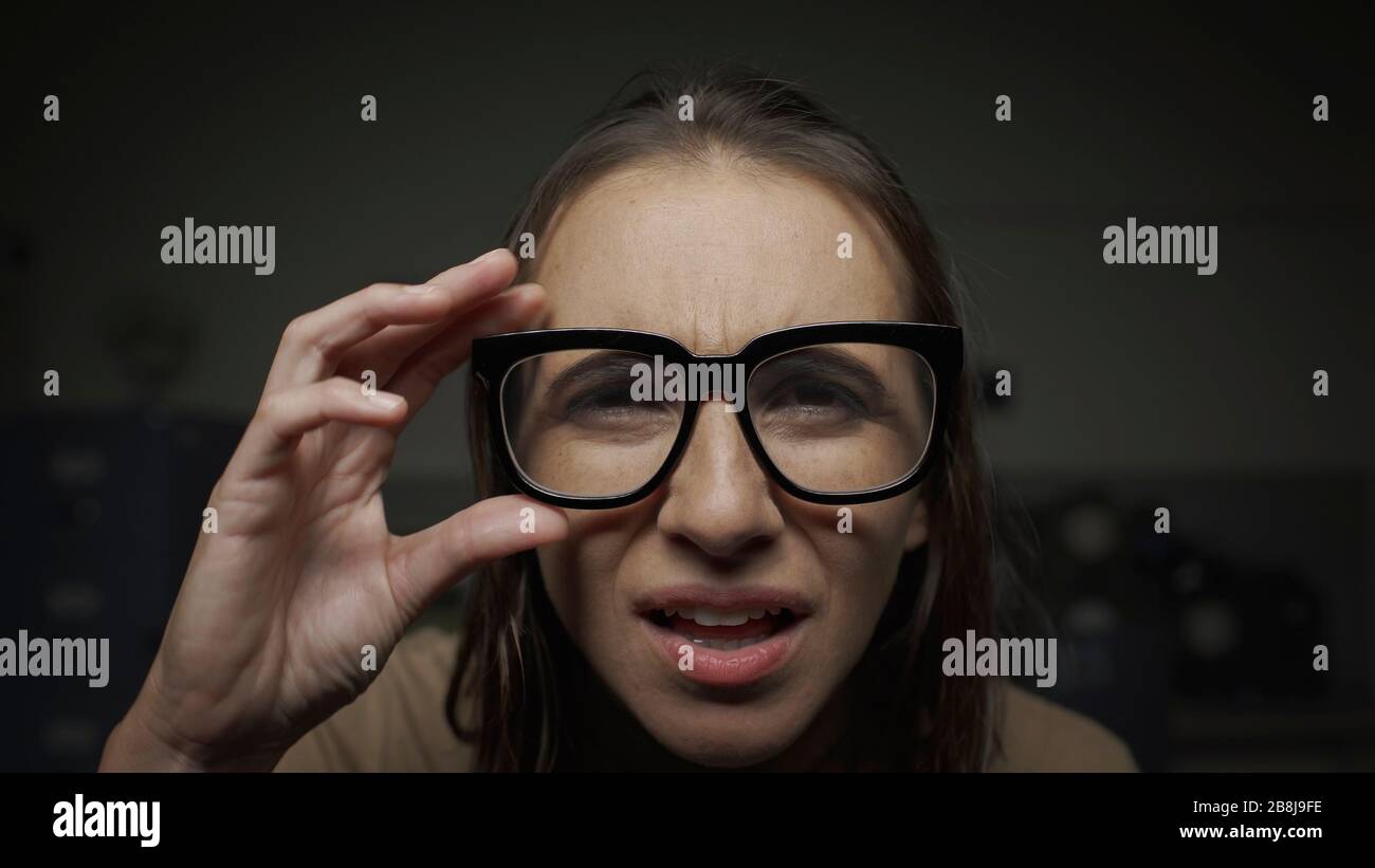 Woman wearing glasses and staring at the computer screen, she has