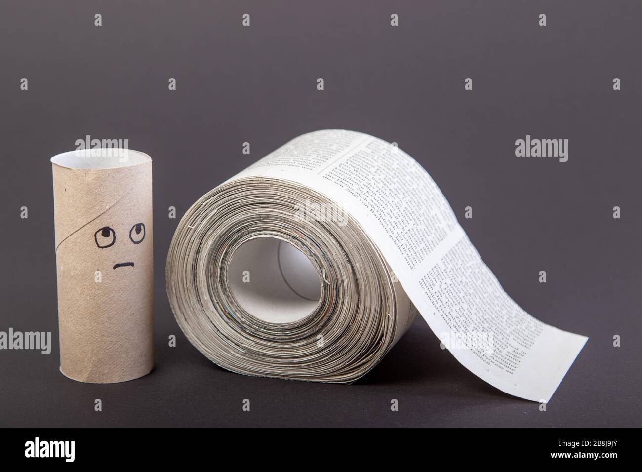 toilet paper made out of newspapers, alternative toilet paper, isolated on  black, newspaper roll, sad face on empty toilet paper roll, close-up Stock  Photo - Alamy