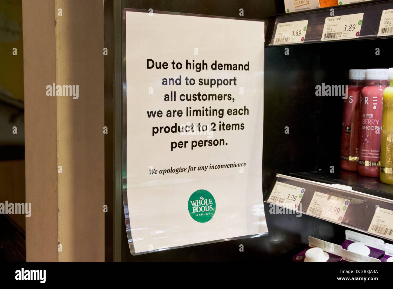 A sign at Whole Foods UK limiting each product to 2 per customer due to food stockpiling during Coronavirus Stock Photo