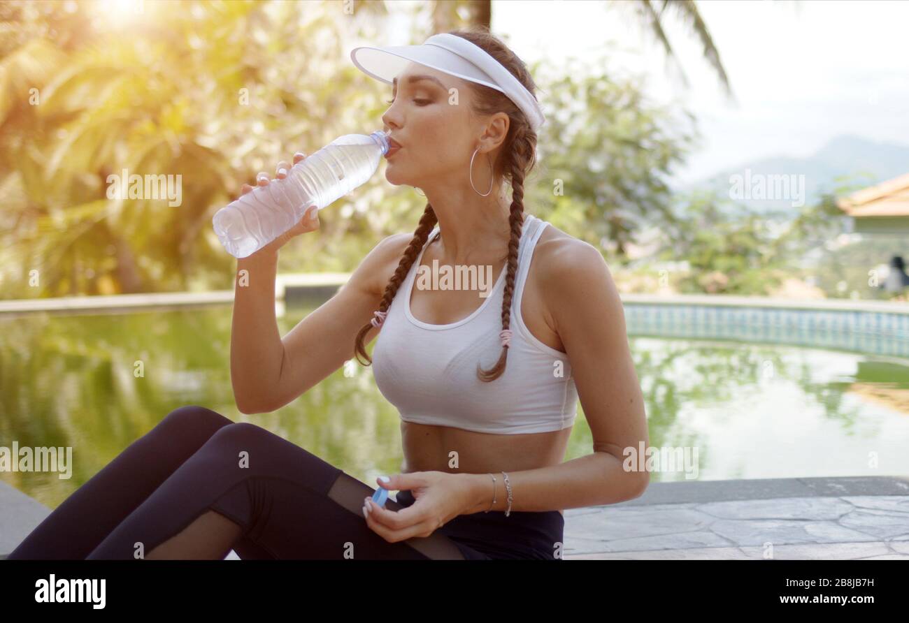 Sporty female drinking water during workout Stock Photo Alamy