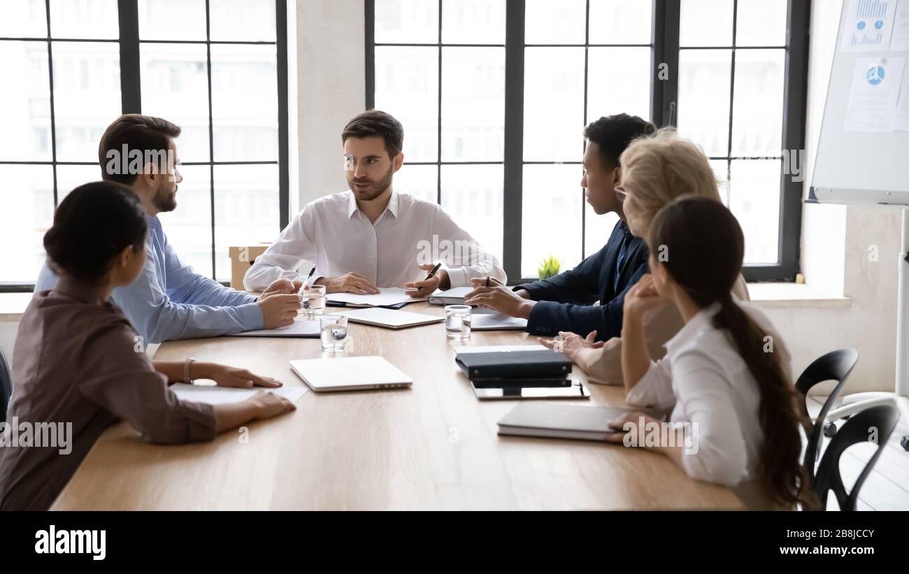 Multiracial businesspeople consider business ideas at briefing Stock Photo