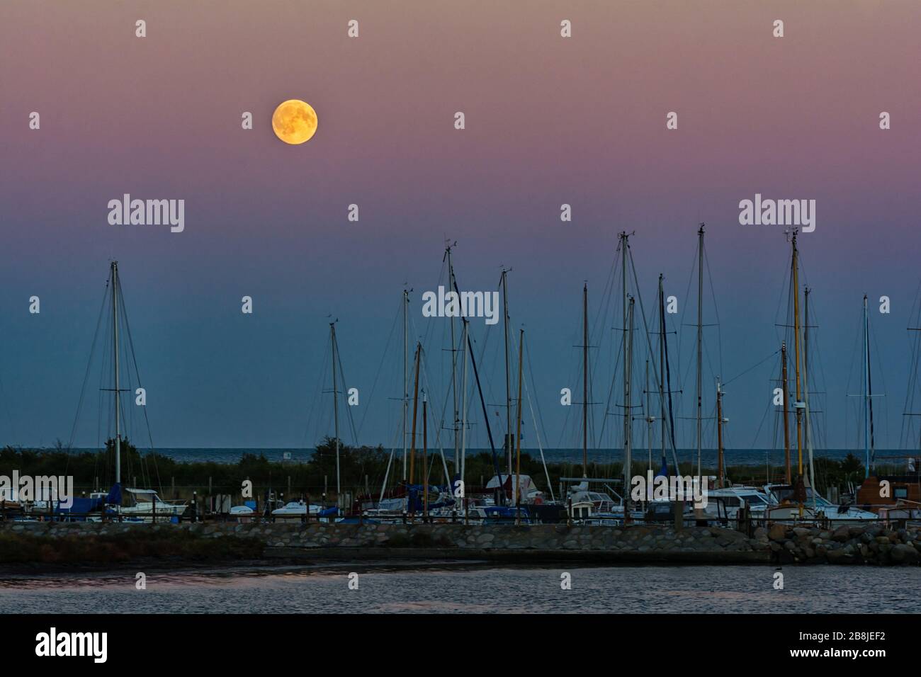 Marina Fehmarnsund on the island of Fehmarn in the Baltic Sea in the moonrise Stock Photo