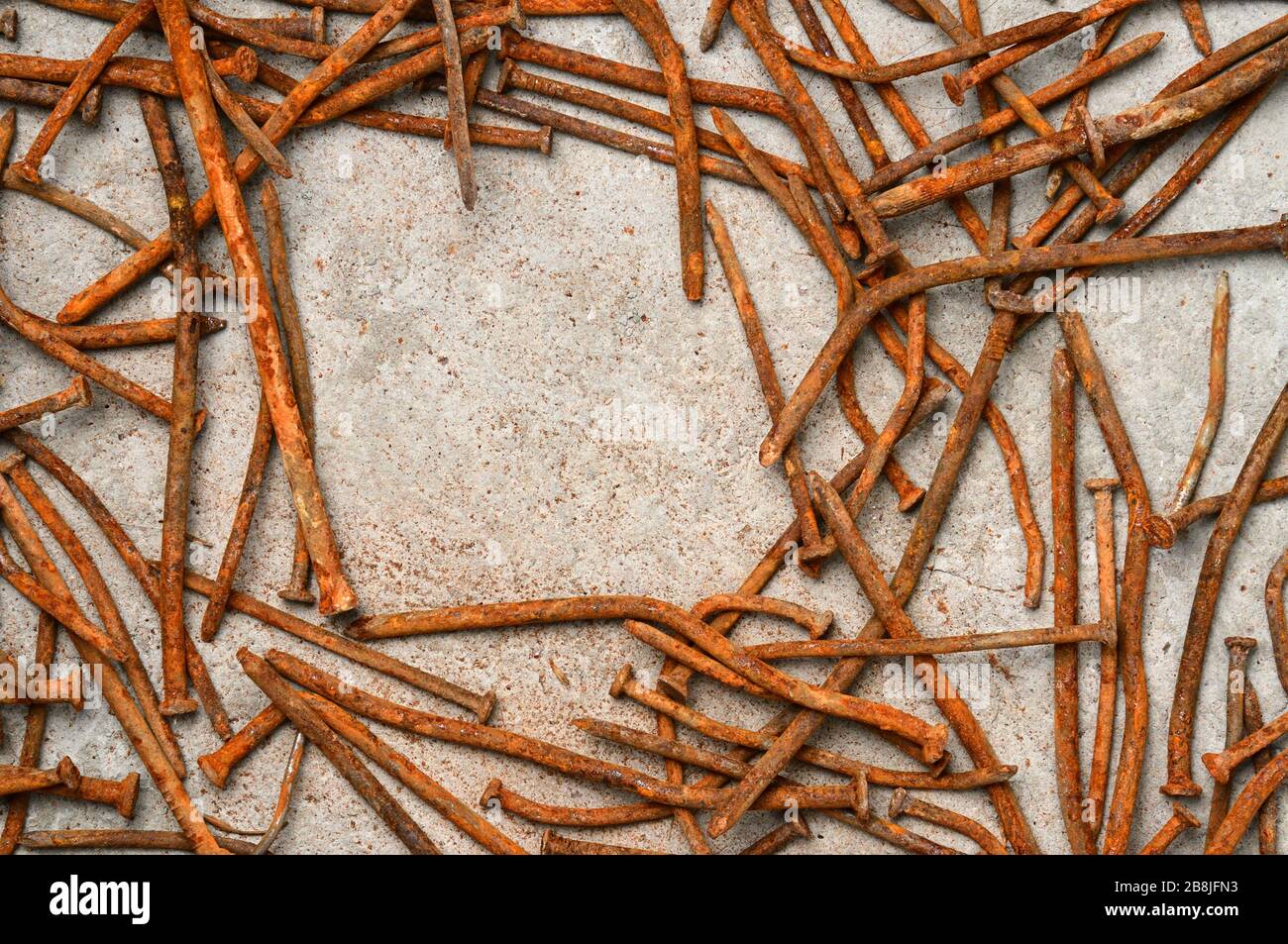 Rusty used nails on a cement metal background Stock Photo