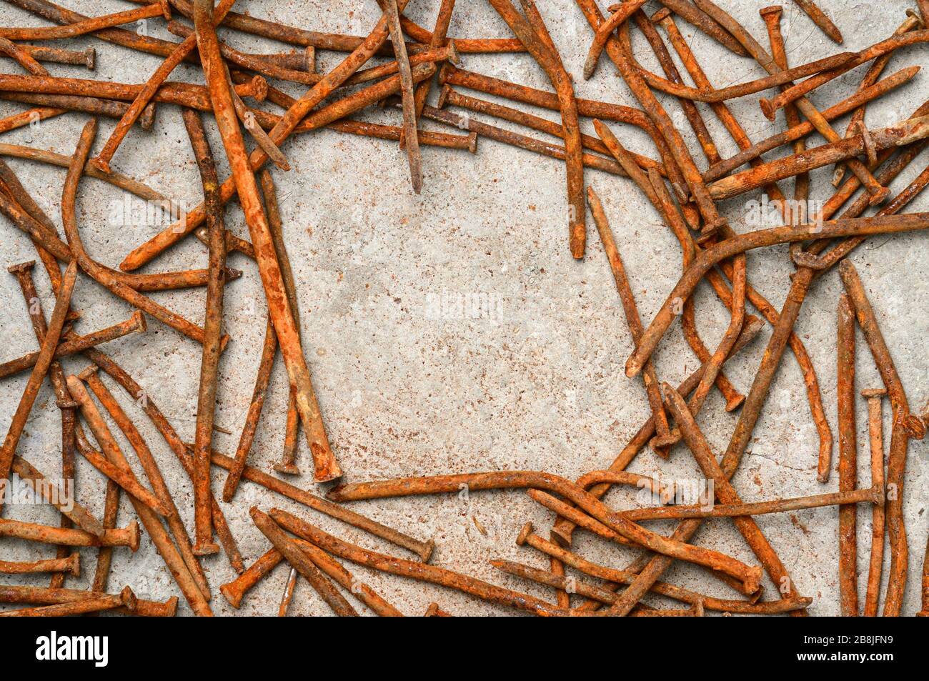 Rusty used nails on a cement metal background Stock Photo