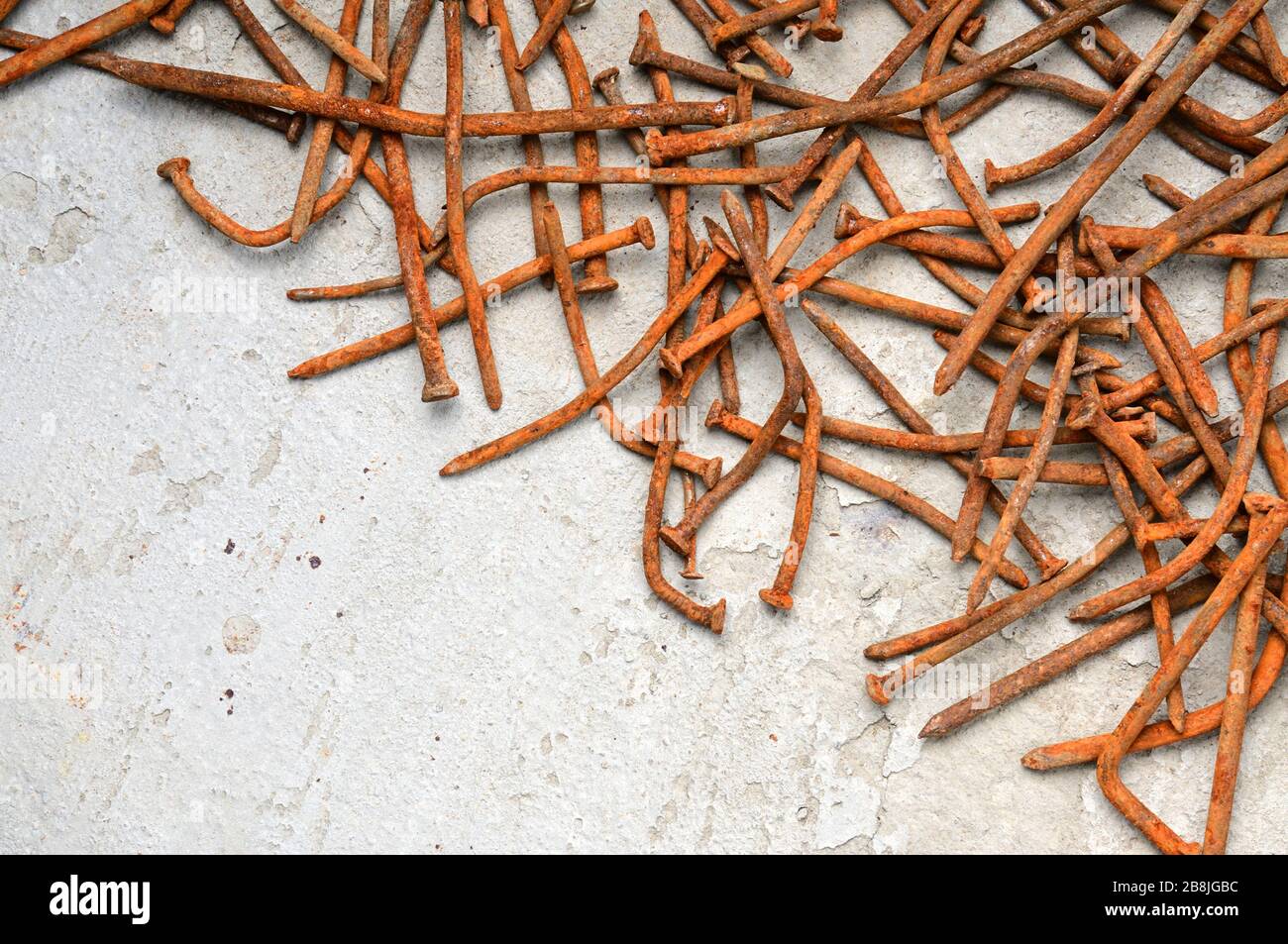 Rusty used nails on a cement metal background Stock Photo