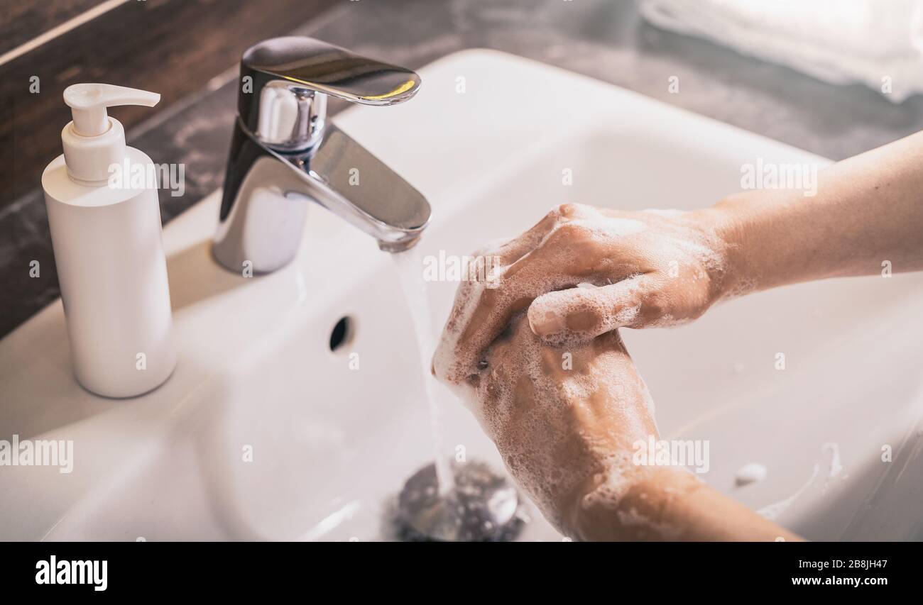 Washing hands with soap and hot water. Prevention coronavirus. Corona Virus (covid 19) pandemic protection by washing hands. Stock Photo