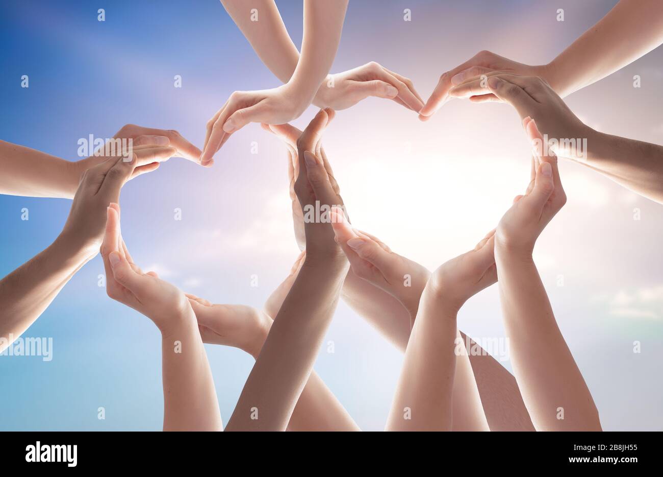 Symbol and shape of heart created from hands.The concept of unity, cooperation, partnership, teamwork and charity. Stock Photo