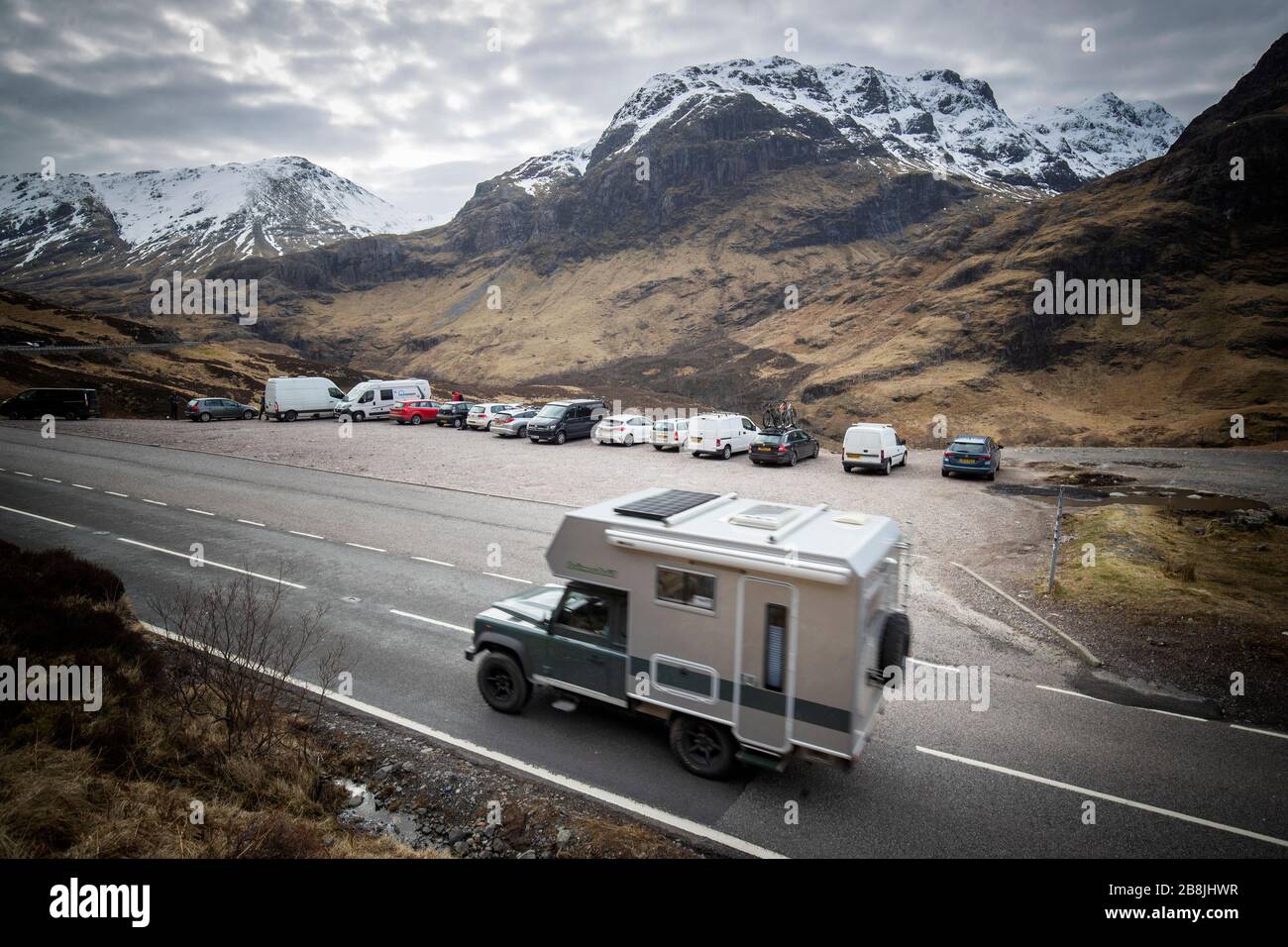 A campervan drives up the Pass of Glencoe, Argyll and Bute. Stock Photo