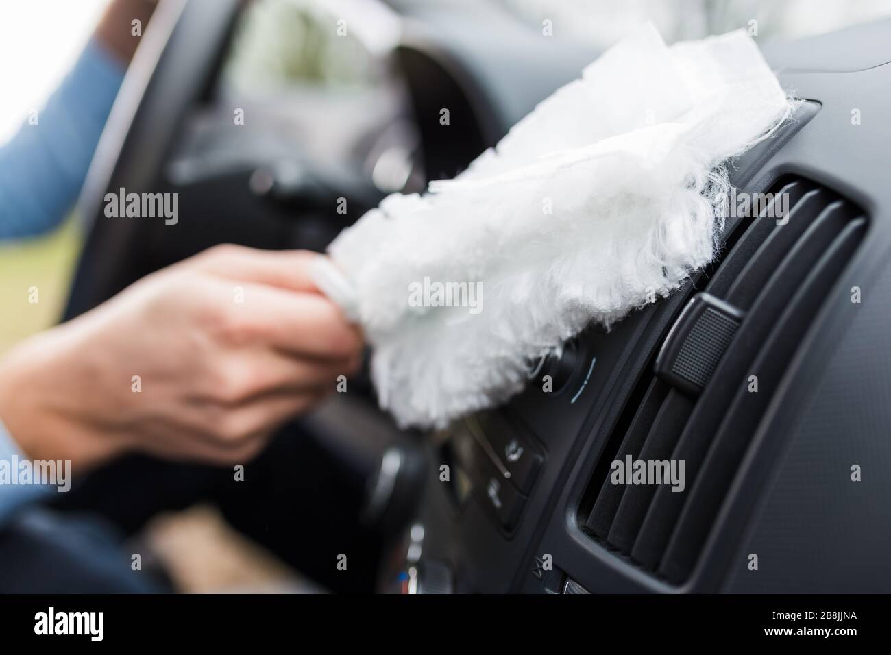 Driver using soft microfiber cleaning brush duster cleaner on car