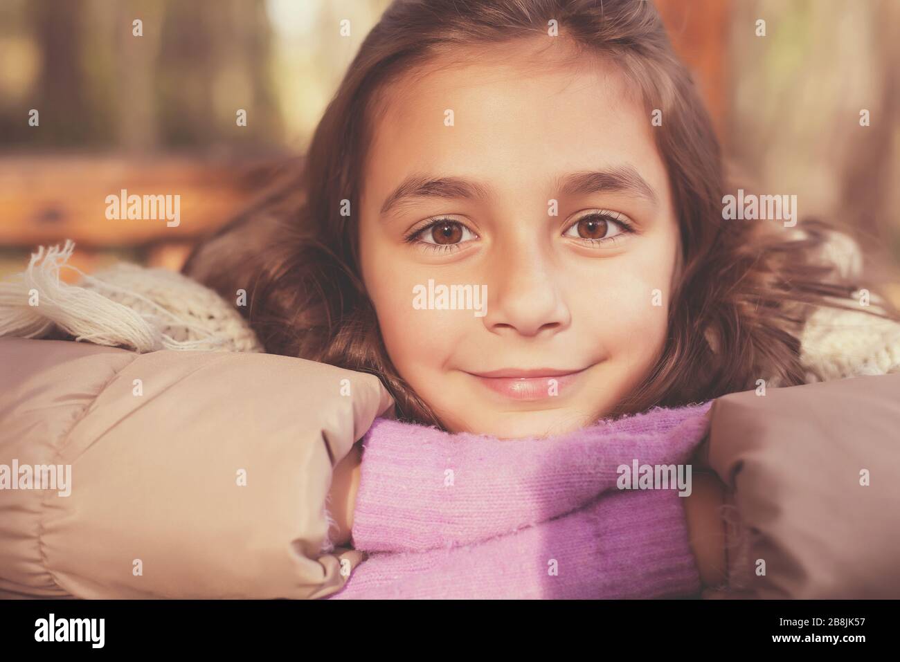 Adorable little girl outdoor in the forest at beautiful autumn day Stock Photo