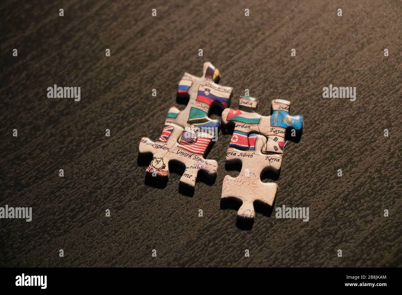 Puzzle pieces that do not fit containing flags of United States and North Korea against dark background. Stock Photo