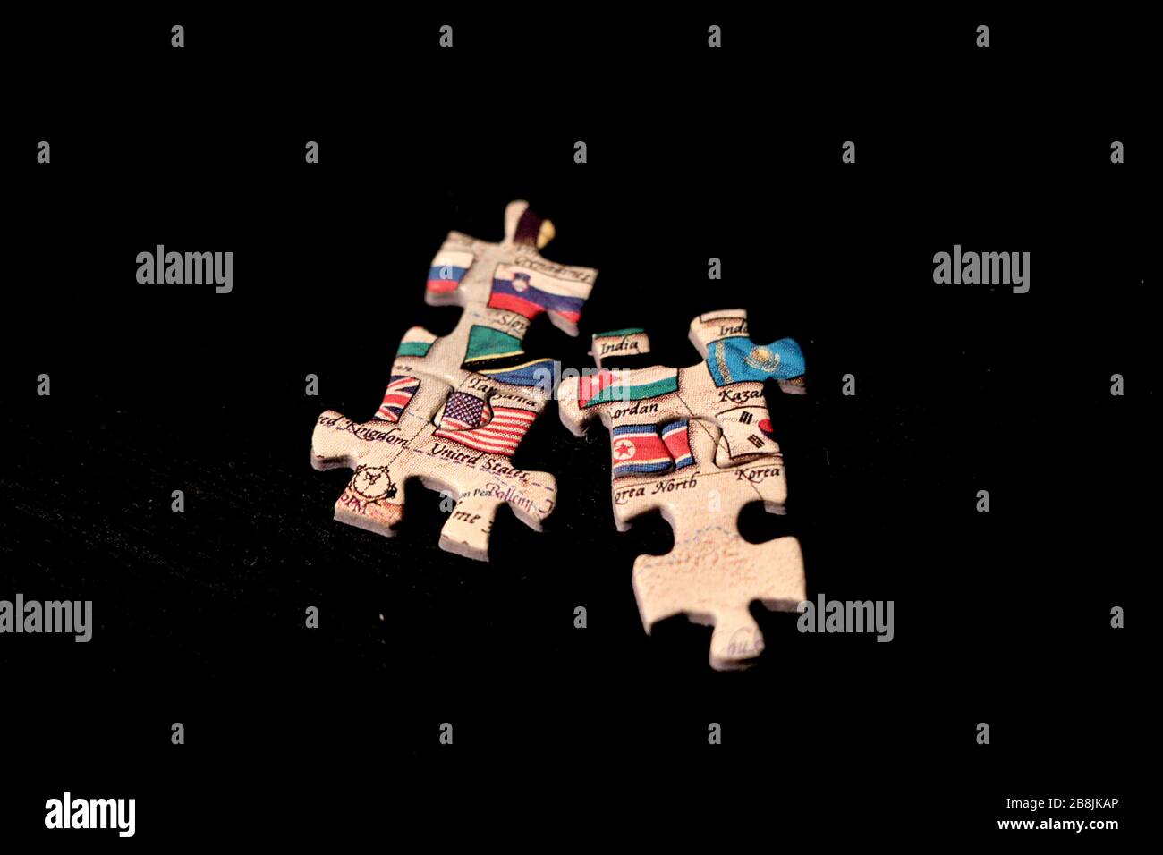 Puzzle pieces that do not fit containing flags of United States and North Korea against dark background. Stock Photo