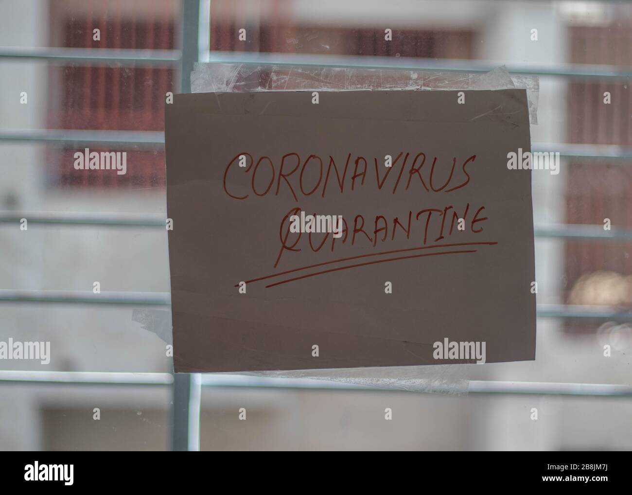 Pandemic coronavirus quarantine sign on front screen door of house, solicitors stay away.Coronavirus quarantine for isolation Stock Photo