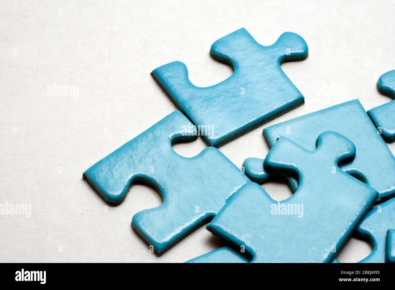 Blue puzzle pieces on white background. Stock Photo