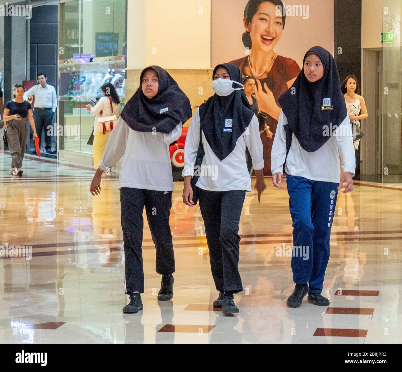 Three female SMKPW students in Suria KLCC Shopping Mall at base of Petronas Towers Kuala Lumpur Malaysia. Stock Photo