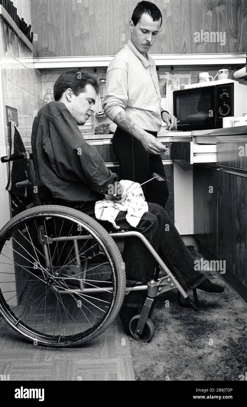 Carer & disabled man UK 1991 Stock Photo