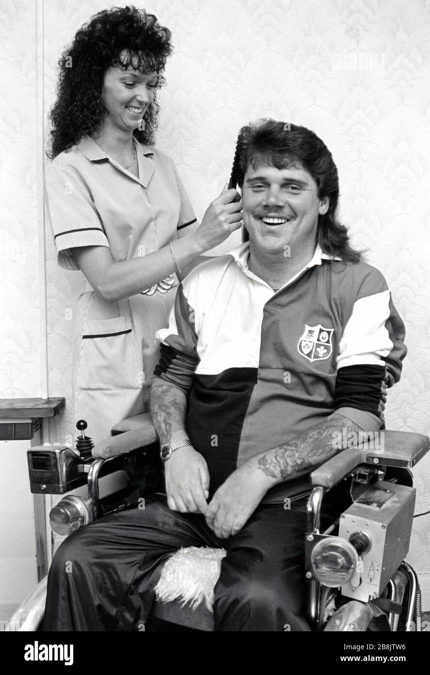 Carer with disabled man UK 1990s Stock Photo