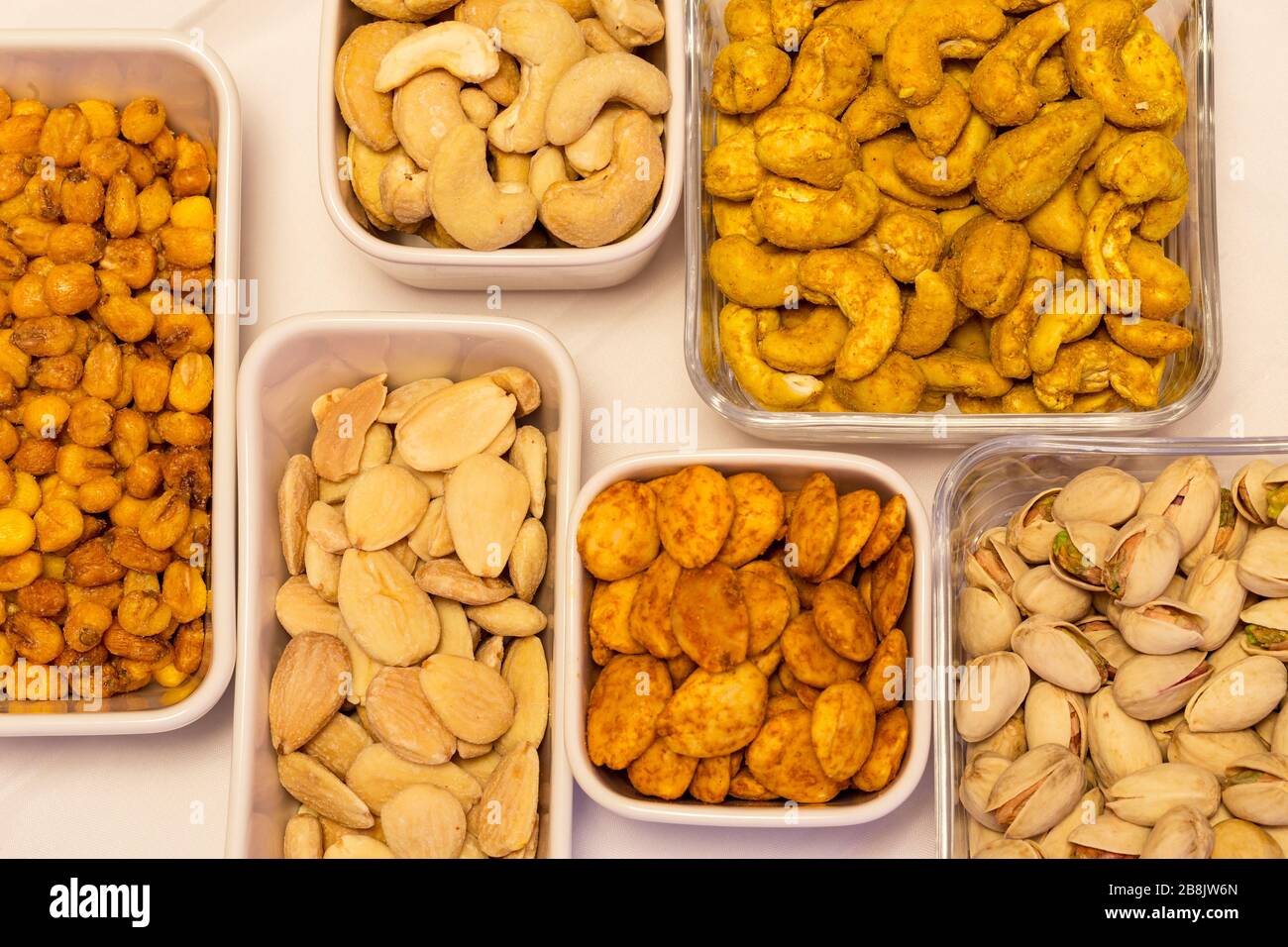 Varieties of nuts cashew, cashew with curry yellow, pistachio, almond