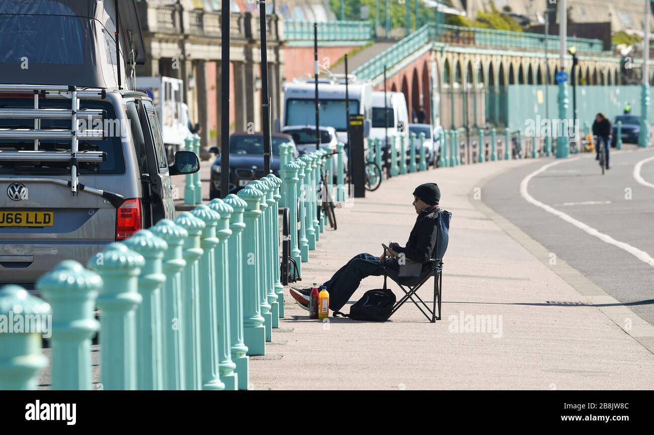 Brighton UK 22nd March 2020 - Visitors enjoy some Spring sunshine today in Brighton during the Coronavirus COVID-19 pandemic crisis . Credit: Simon Dack / Alamy Live News Stock Photo