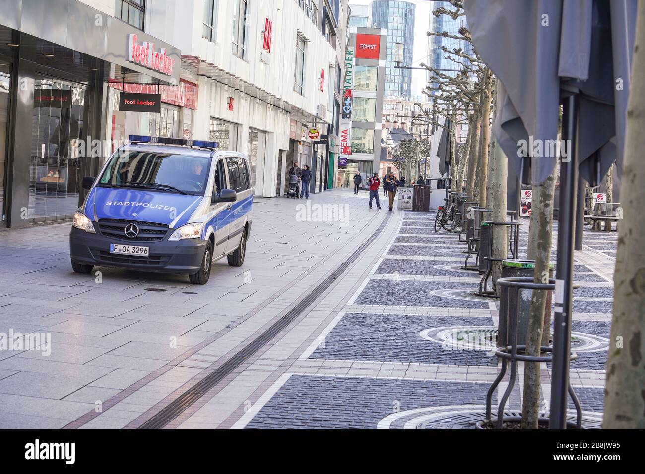 22 March 2020, Hessen, Frankfurt/Main: A police car rolls over Frankfurt's  Zeil shopping mile, which