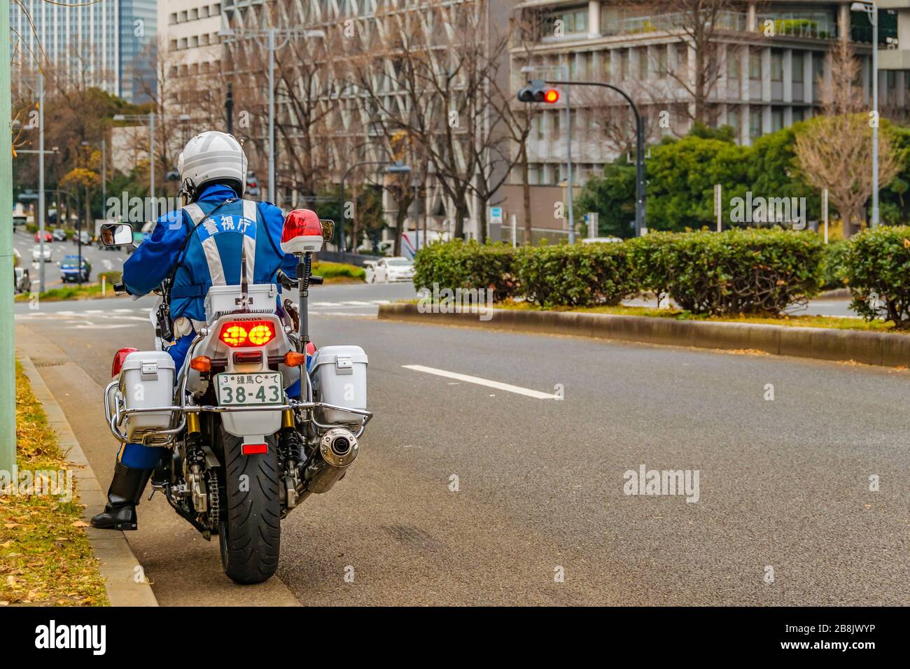 TOKYO, JAPAN, JANUARY - 2019 - Back view police traffic at motorcycle standing at avenue, chiyoda district, tokyo, japan Stock Photo