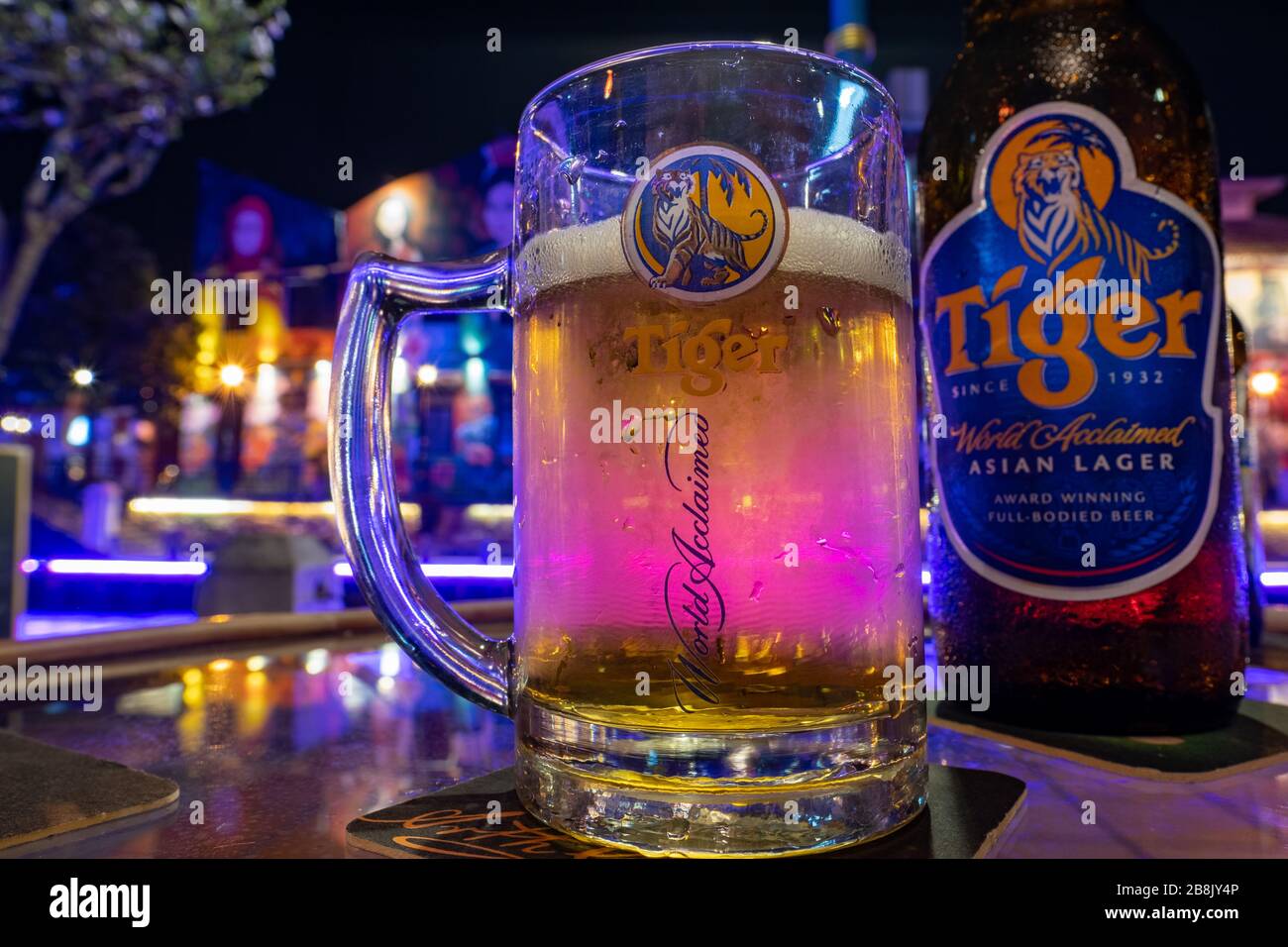 A cold glass and bottle of Tiger Beer, a lager beer made in Singapore Stock Photo