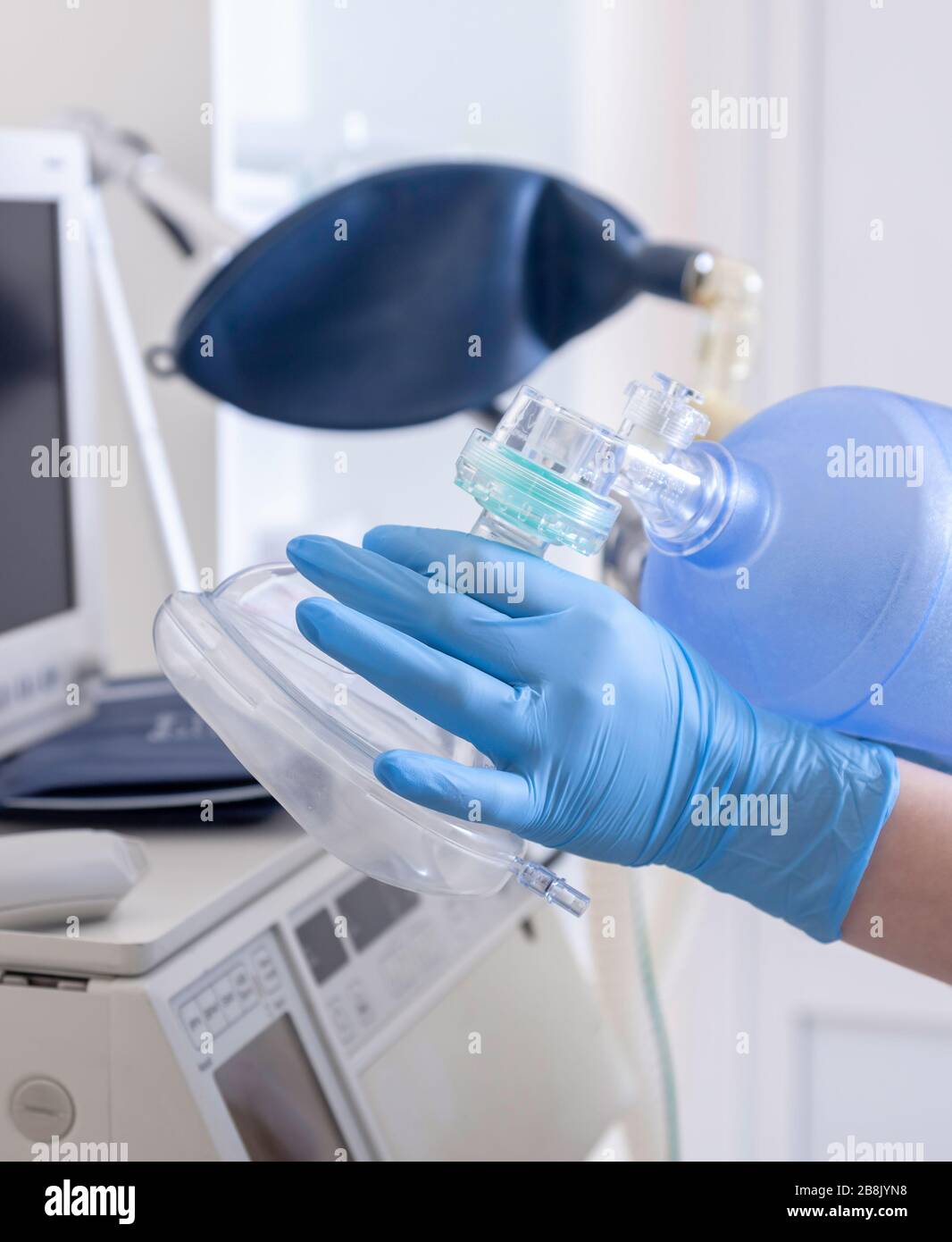 Device for anesthesia in the operating room. Hand with tool for oxygen during the surgery. Stock Photo