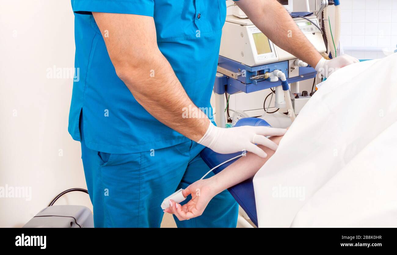 Device for anesthesia in the operating room. Hand with tool for oxygen during the surgery. Stock Photo