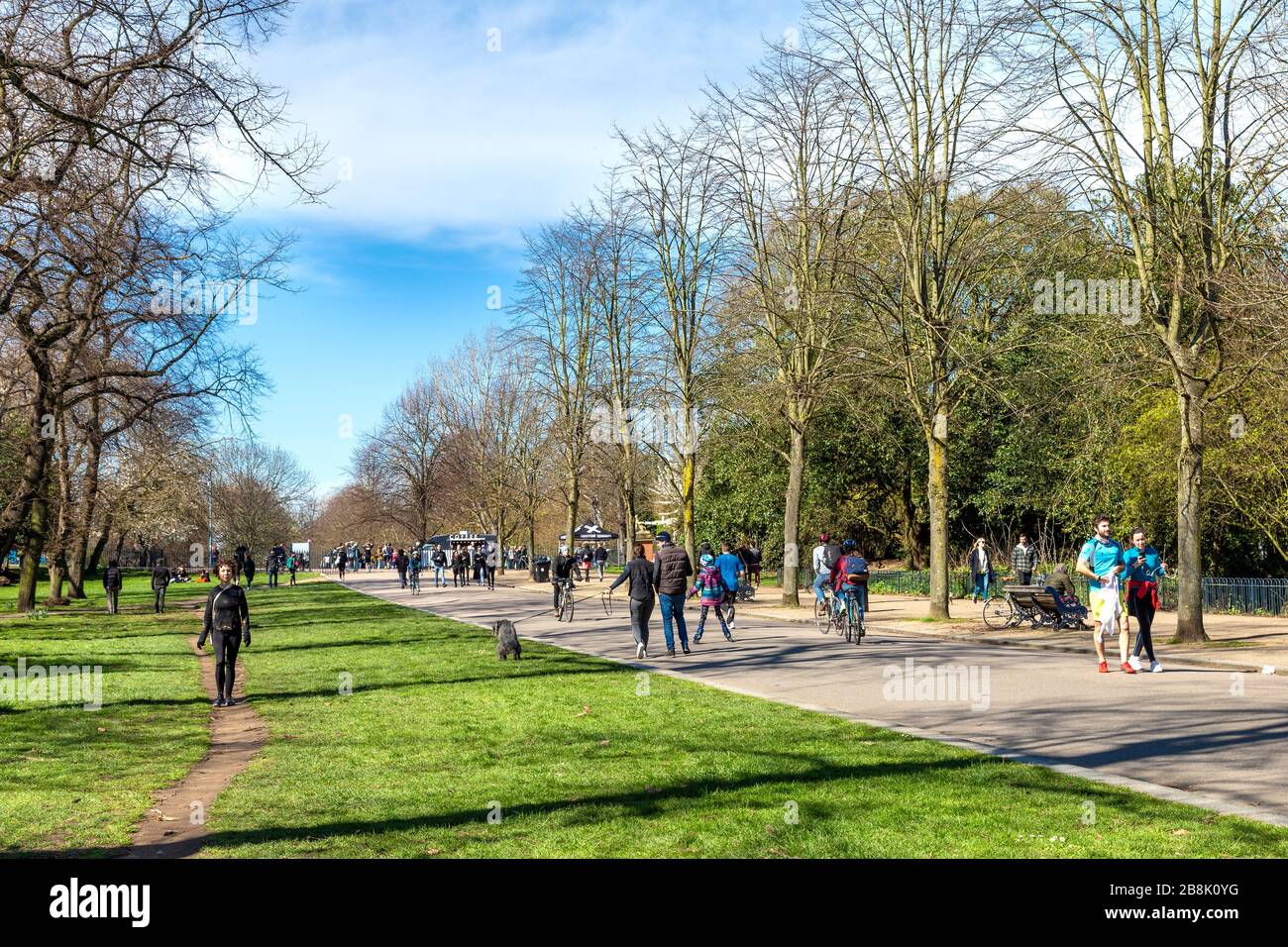 22 March 2020 - London, UK - global coronavirus pandemic, big groups of people visiting Victoria Park despite government urging people to stay at home and practice social distancing to prevent the spread of the coronavirus Covid-19, people going for a walk in the park Stock Photo