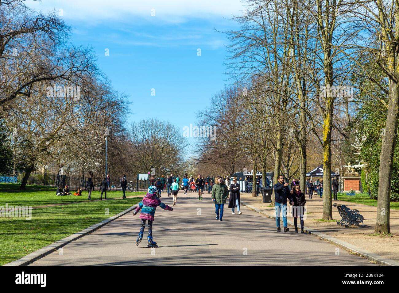 22 March 2020 - London, UK - global coronavirus pandemic, big groups of people visiting Victoria Park despite government urging people to stay at home and practice social distancing to prevent the spread of the coronavirus Covid-19, people going for a walk in the park Stock Photo