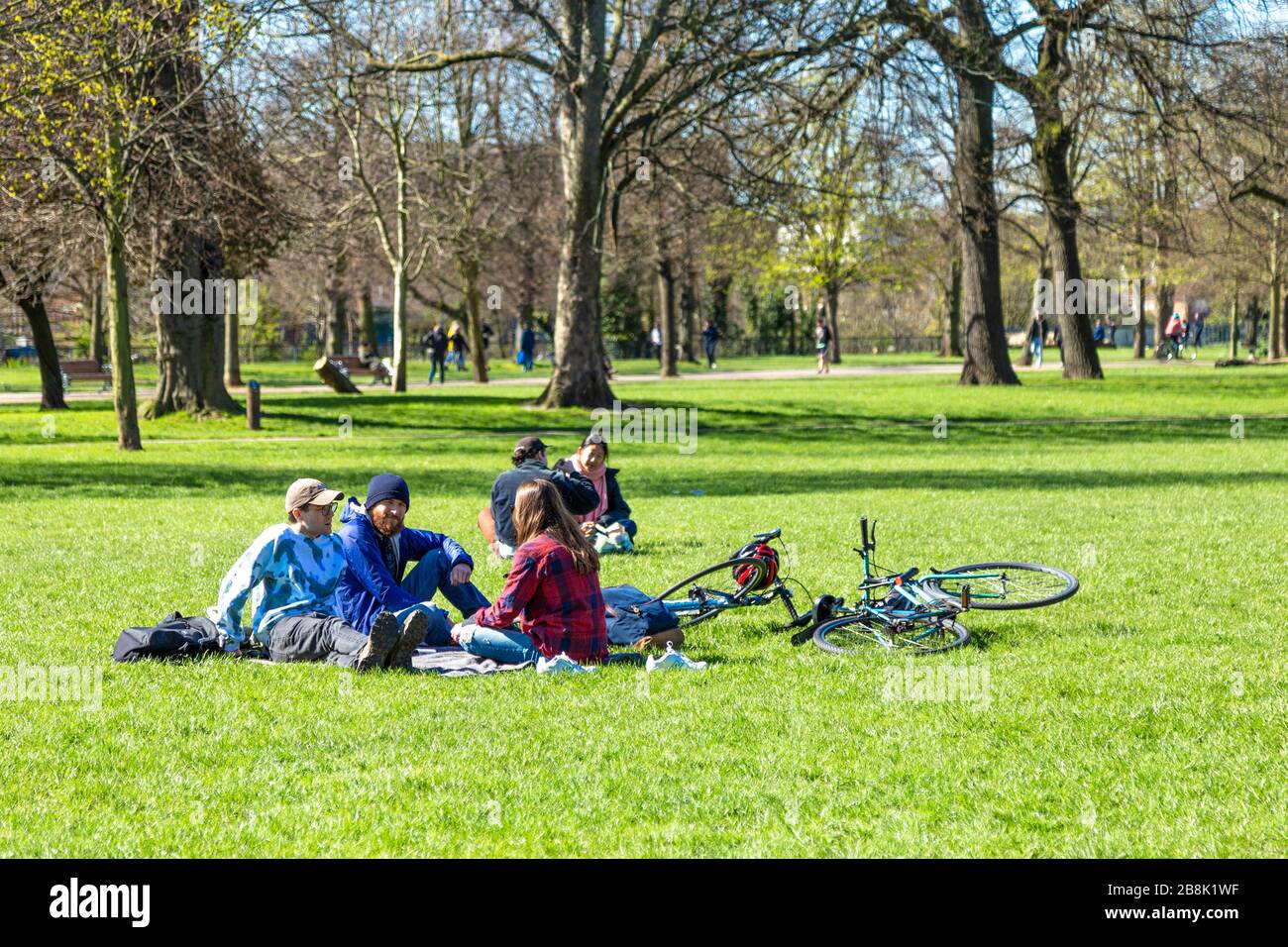 22 March 2020 - London, UK - global coronavirus pandemic, big groups of people visiting Victoria Park despite government urging people to stay at home and practice social distancing to prevent the spread of the coronavirus Covid-19, people having a picnic in the park Stock Photo