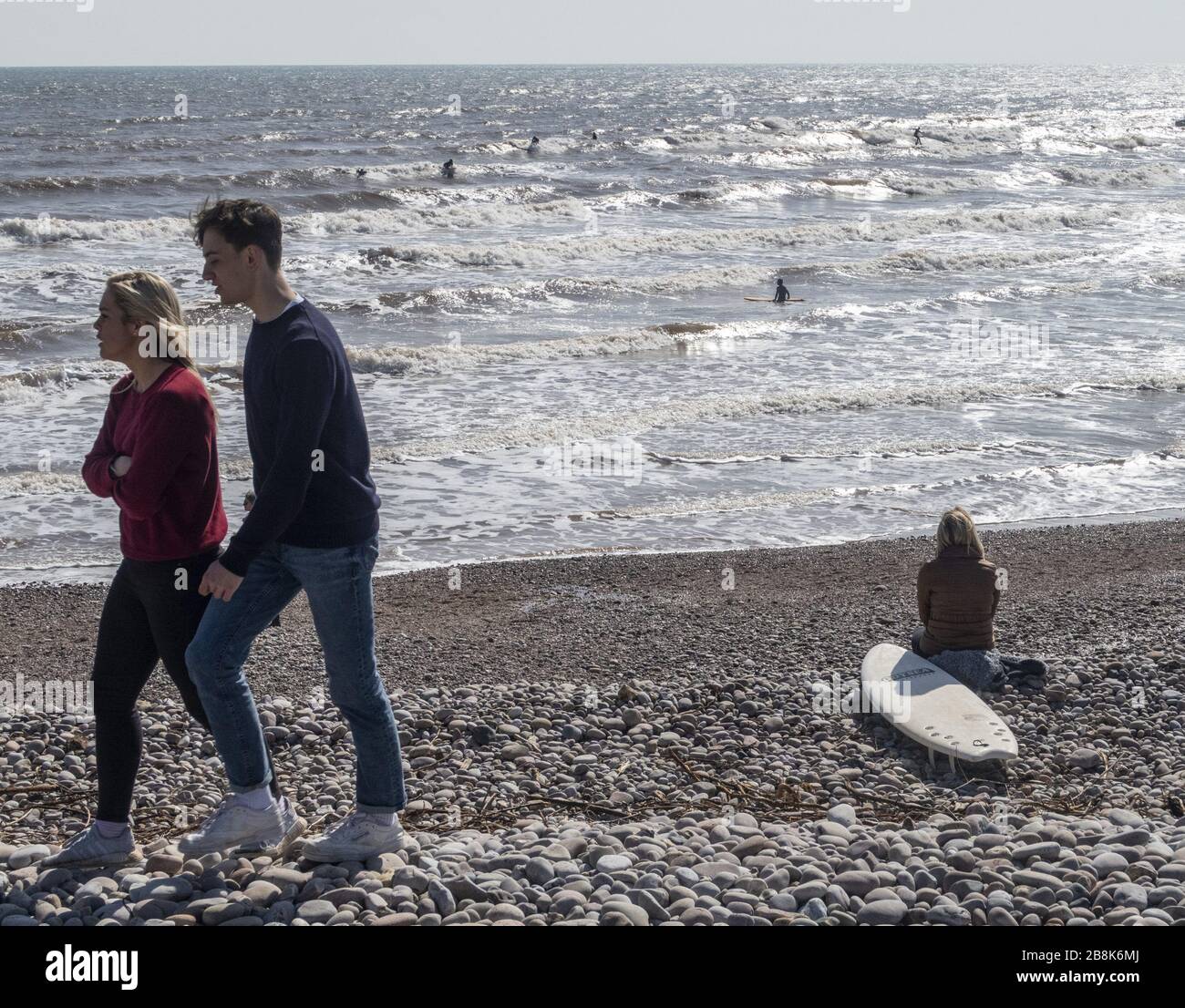 Sidmouth, Devon, 22nd March 20 Plenty of room on the beach at Sidmouth to keep some social distance from others on a glorious sunny day in Devon. Credit: Photo Central/Alamy Live News Stock Photo