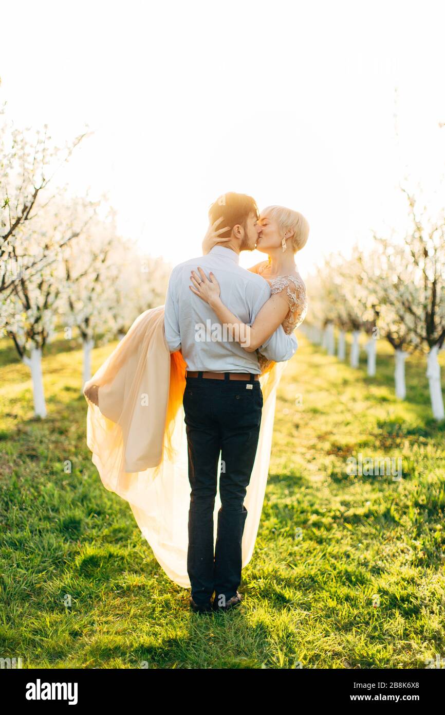 Couple kissing at blooming tree hi-res stock photography and images - Alamy