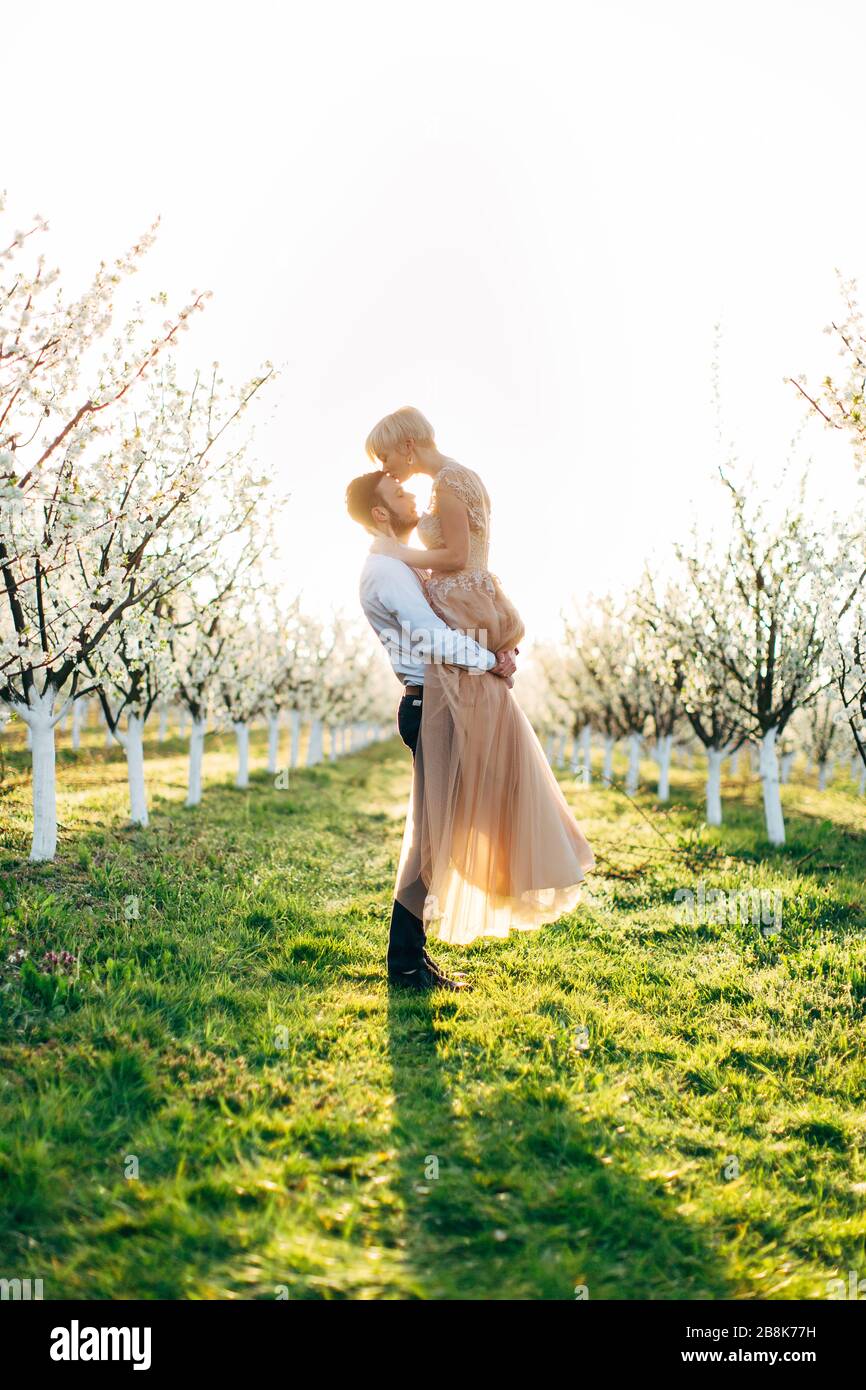 Couple kissing at blooming tree hi-res stock photography and images - Alamy