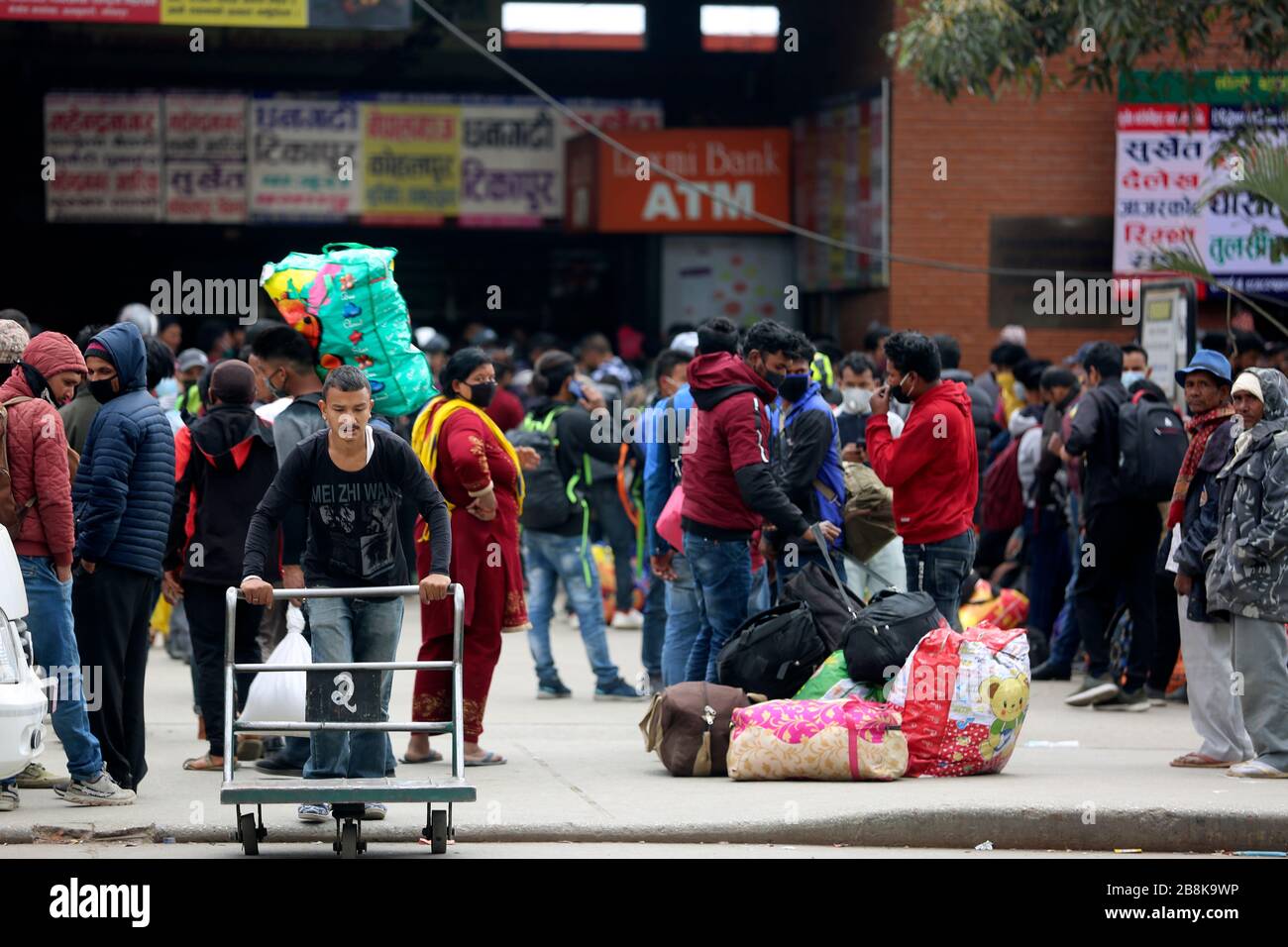Kathmandu, Nepal. 22nd Mar, 2020. Passengers are seen at a coach station in Kathmandu, Nepal, March 22, 2020. Nepali Prime Minister KP Sharma Oli on March 20 announced a number of prohibitive measures including suspension of long-distance transport operation amid COVID-19 outbreak. In an address to the nation on Friday evening, the prime minister announced that all the long-haul transportation services will be halted from March 23. Credit: Zhou Shengping/Xinhua/Alamy Live News Stock Photo