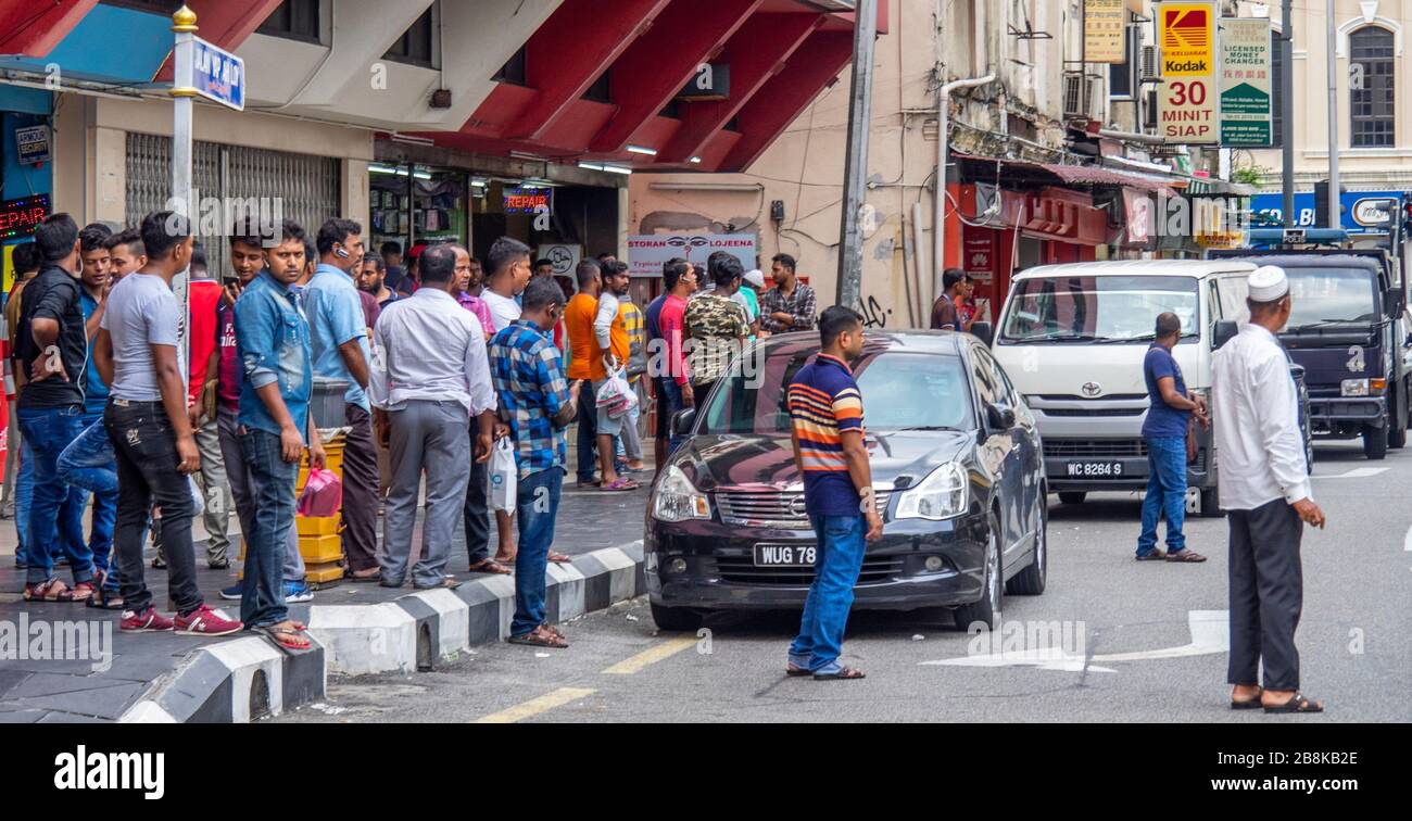 Indian men walking gathering and loitering along Jalan Yap Ah Loy Chinatown Kuala Lumpur Malaysia. Stock Photo