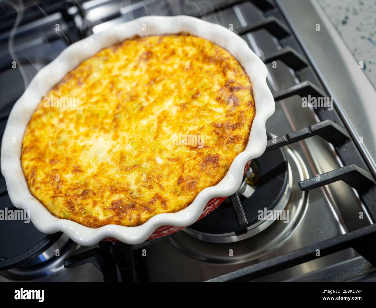 Quiche with steam rising cooling on stove top, USA Stock Photo Alamy