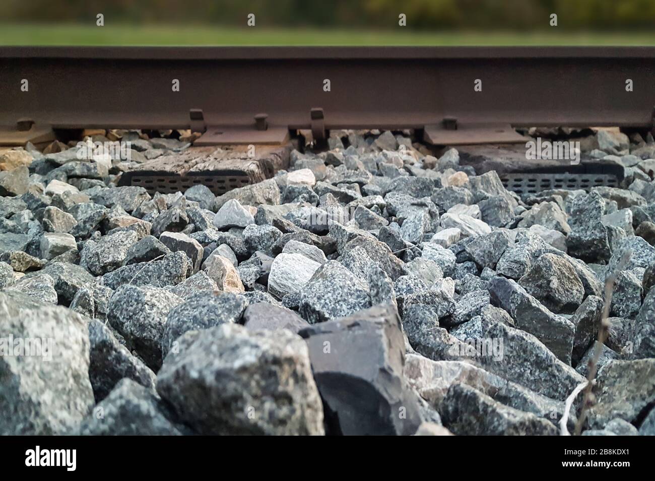 Low angle side view of railroad bed with train tracks Stock Photo