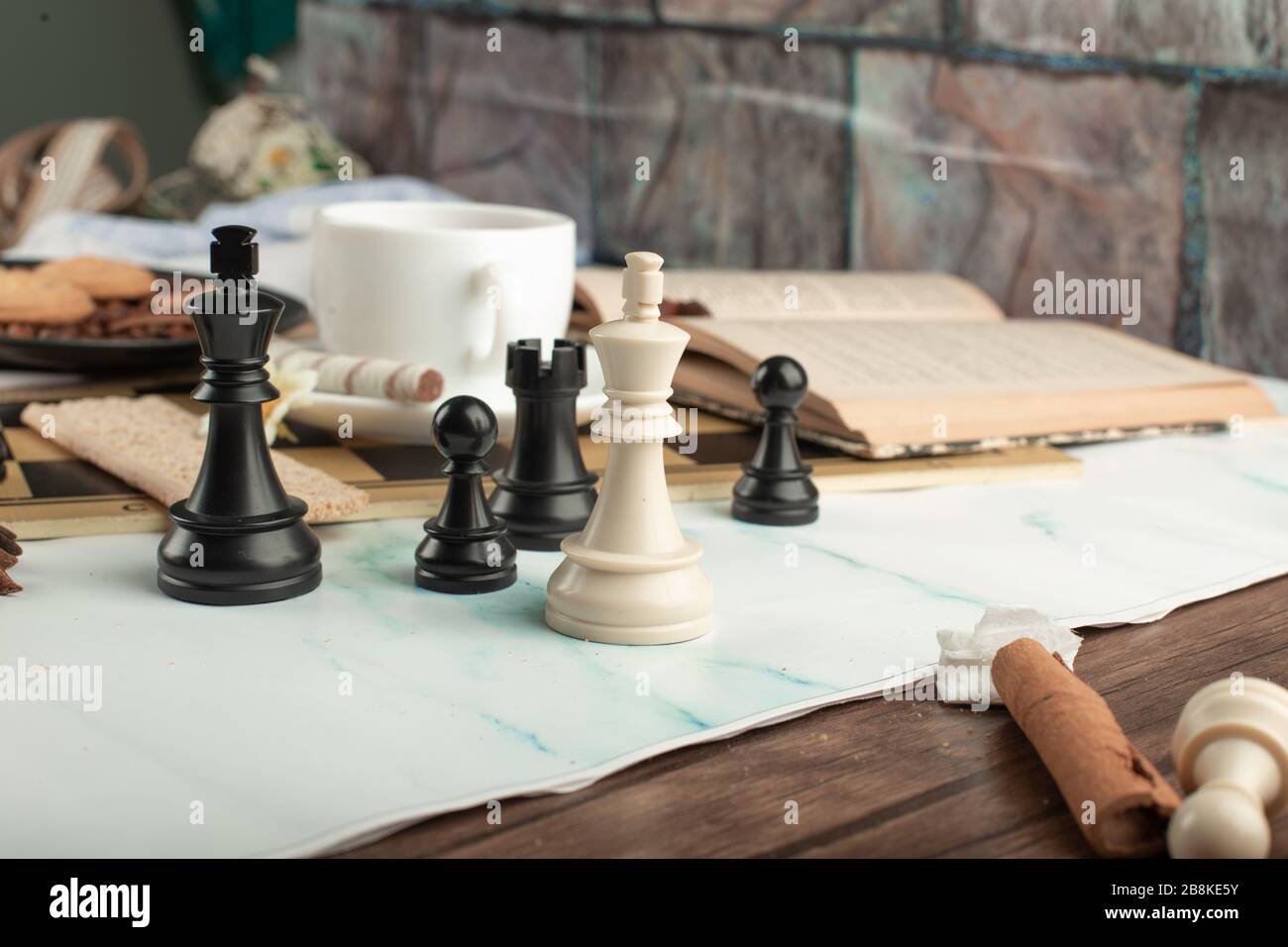 Chess figures and a book on the table Stock Photo